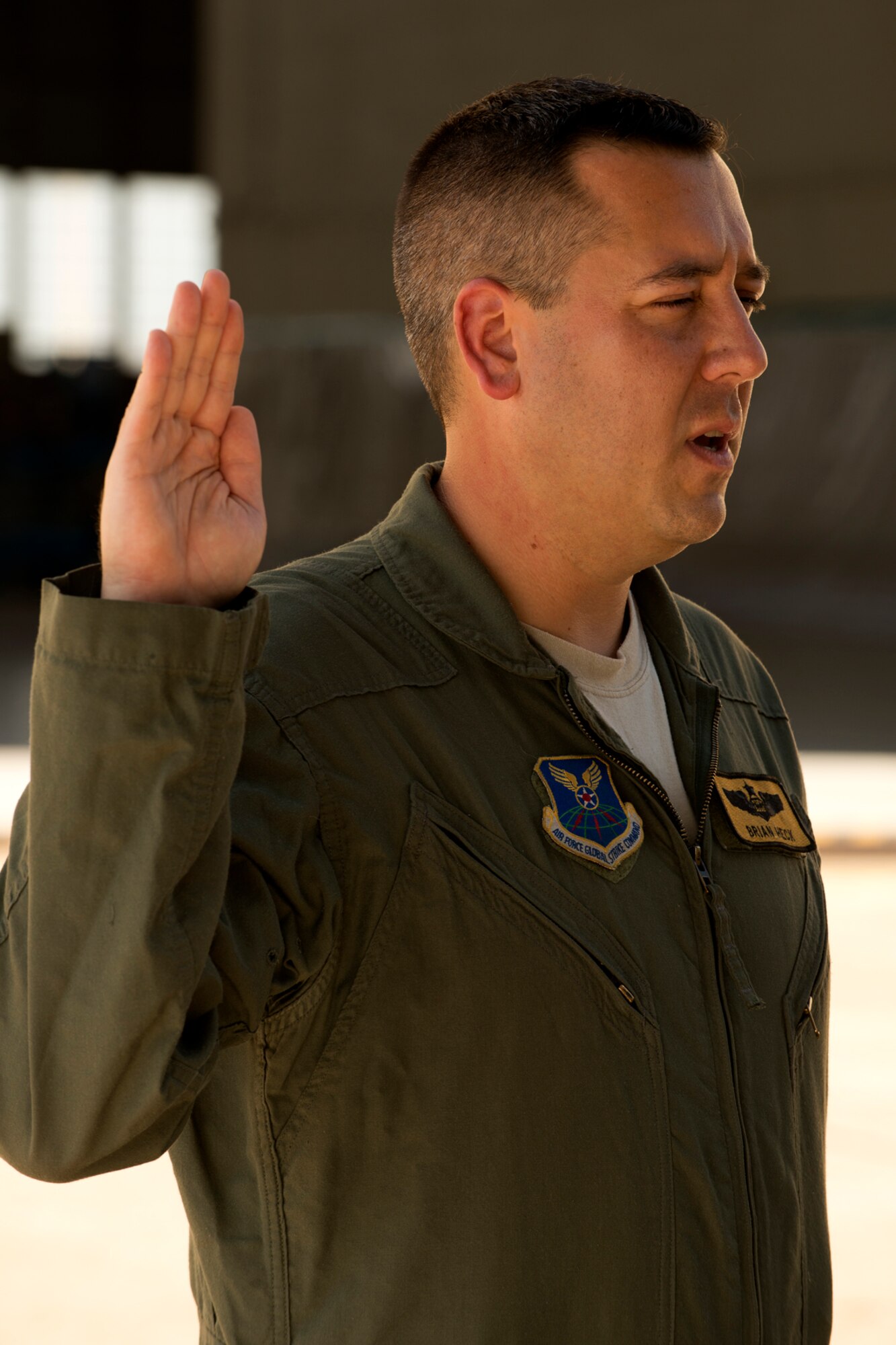 U.S. Air Force Maj. Brian Heck repeats the oath during a Pinning On ceremony, Sept. 28, 2012, Barksdale Air Force Base, La. Heck is assigned to the 11th Bomb Squadron at Barksdale. (U.S. Air Force photo by Master Sgt. Greg Steele/Released)