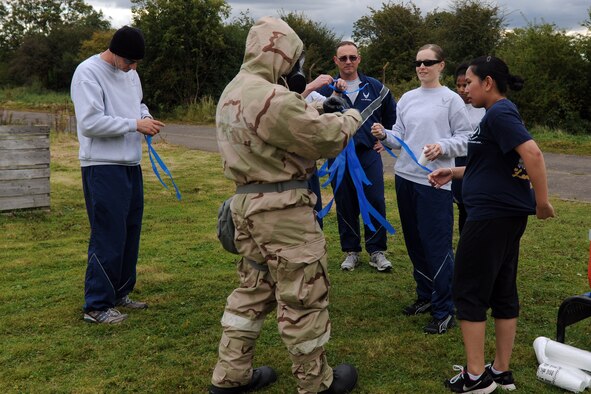 RAF MOLESWORTH, United Kingdom –Members of the 501st Combat Support Wing receive new flags at the recovery area after being chased by zombies through a village during the Zombie Survival 5K Run held by the 501st Combat Support Wing Emergency Management Flight Sept. 28 on RAF Molesworth, United Kingdom. The run was held in support of National Preparedness Month. (U.S. Air Force photo by Staff Sgt. Brian Stives)