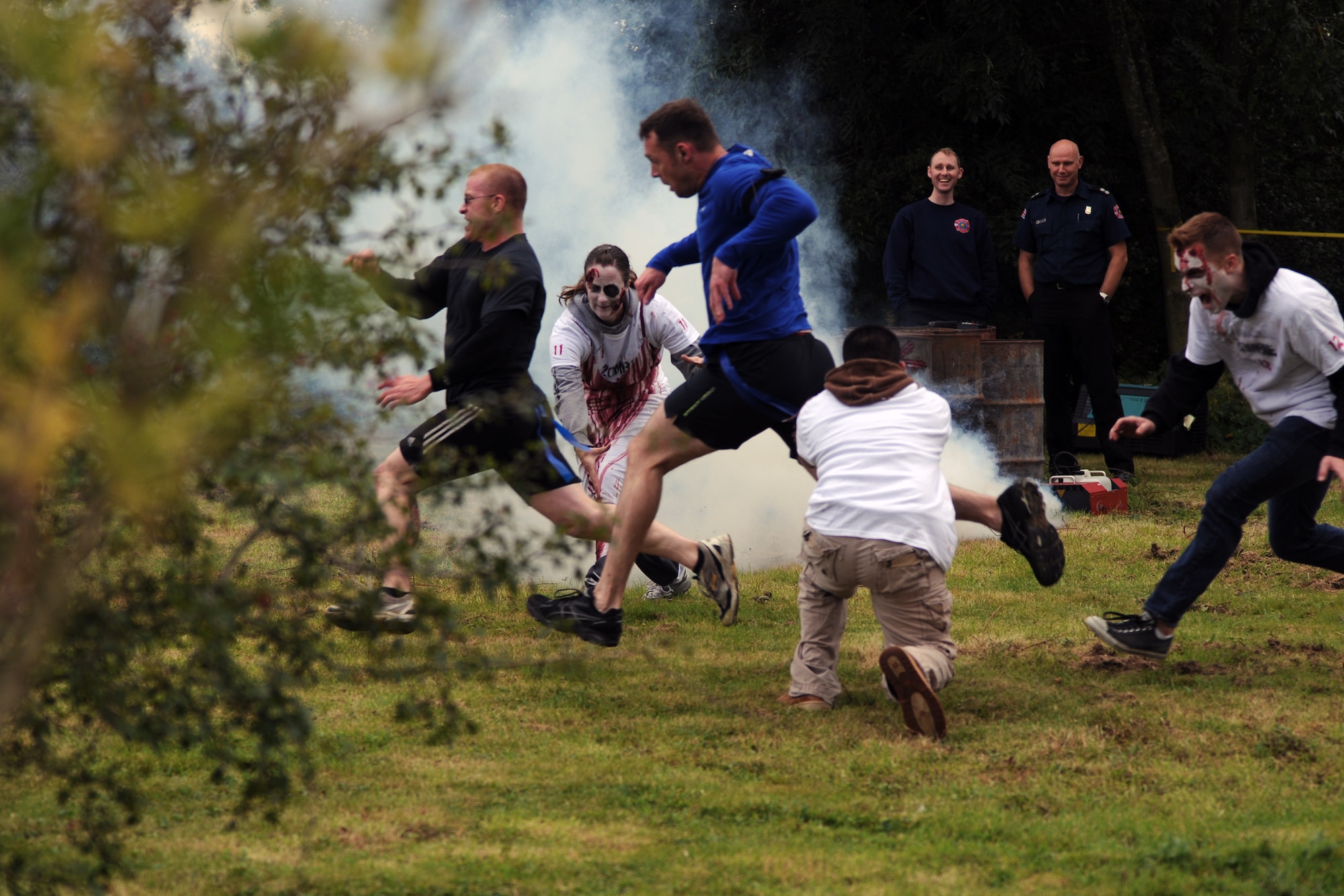 RAF MOLESWORTH, United Kingdom –Members of the 501st Combat Support Wing are chased by zombies through a village during the Zombie Survival 5K Run held by the 501st Combat Support Wing Emergency Management Flight Sept. 28 on RAF Molesworth, United Kingdom. The run was held in support of National Preparedness Month. (U.S. Air Force photo by Staff Sgt. Brian Stives)