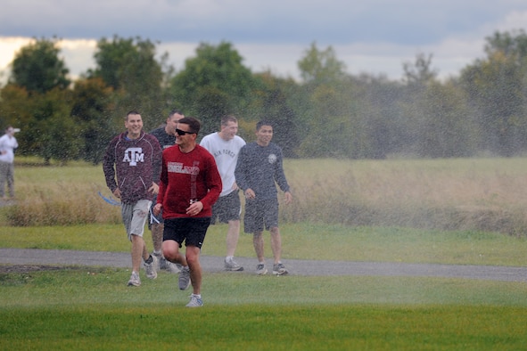 RAF MOLESWORTH, United Kingdom –Members of the 501st Combat Support Wing go through the decontamination area of the Zombie Survival 5K Run held by the 501st Combat Support Wing Emergency Management Flight Sept. 28 on RAF Molesworth, United Kingdom. The run was held in support of National Preparedness Month. (U.S. Air Force photo by Master Sgt. John Barton)