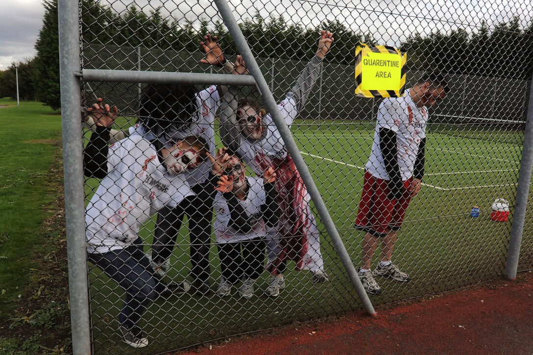 RAF MOLESWORTH, United Kingdom – Zombies wait to get out of the quarantine area on RAF Molesworth, United Kingdom, at the start of the Zombie Survival 5K Run held by the 501st Combat Support Wing Emergency Management Flight Sept. 28. The run was held in support of National Preparedness Month. (U.S. Air Force photo by Master Sgt. John Barton)
