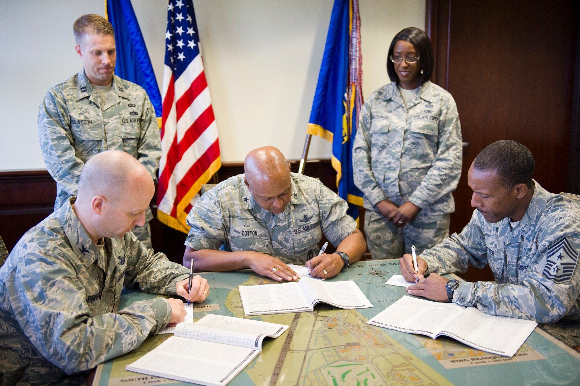 Brig. Gen. Anthony Cotton, center, commander, 45th Space Wing, Col. Robert
Pavelko, left, vice commander, 45th Space wing, and Chief Master Sgt. Herman
Moyer, 45th Space Wing command chief, sign the forms for this year's
Combined Federal Campaign. The campaign opened Monday and will run through
Oct. 31. Our team goal this year is $200,000. Also pictured are Capt. Billy
Clayton, standing left, and Senior Master Sgt. Marcia Scantlebury Hall, both
from the 45th Force Support Squadron, who are "CFC Key Persons" for the
campaign. Photo by Julie Dayringer. 
