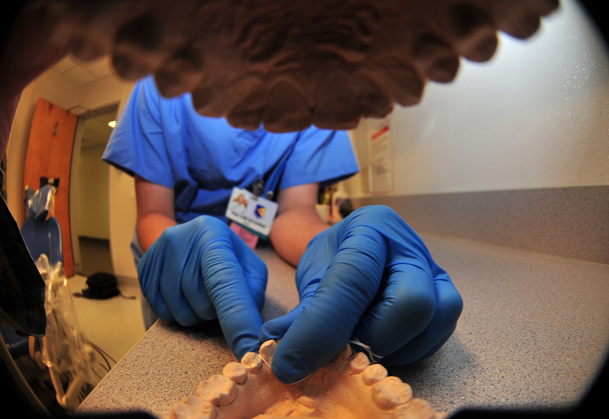 U.S. Air Force Staff Sgt. Cami Richards, 355th Dental Squadron dental assistant, demonstrates the proper way to floss your teeth on Davis-Monthan Air Force Base, Ariz., Sept. 25, 2012. The 355th Dental Squadron does everything from simple annual exams to periodontal surgery. (U.S. Air Force photo by Airman 1st Class Josh Slavin/Released)
