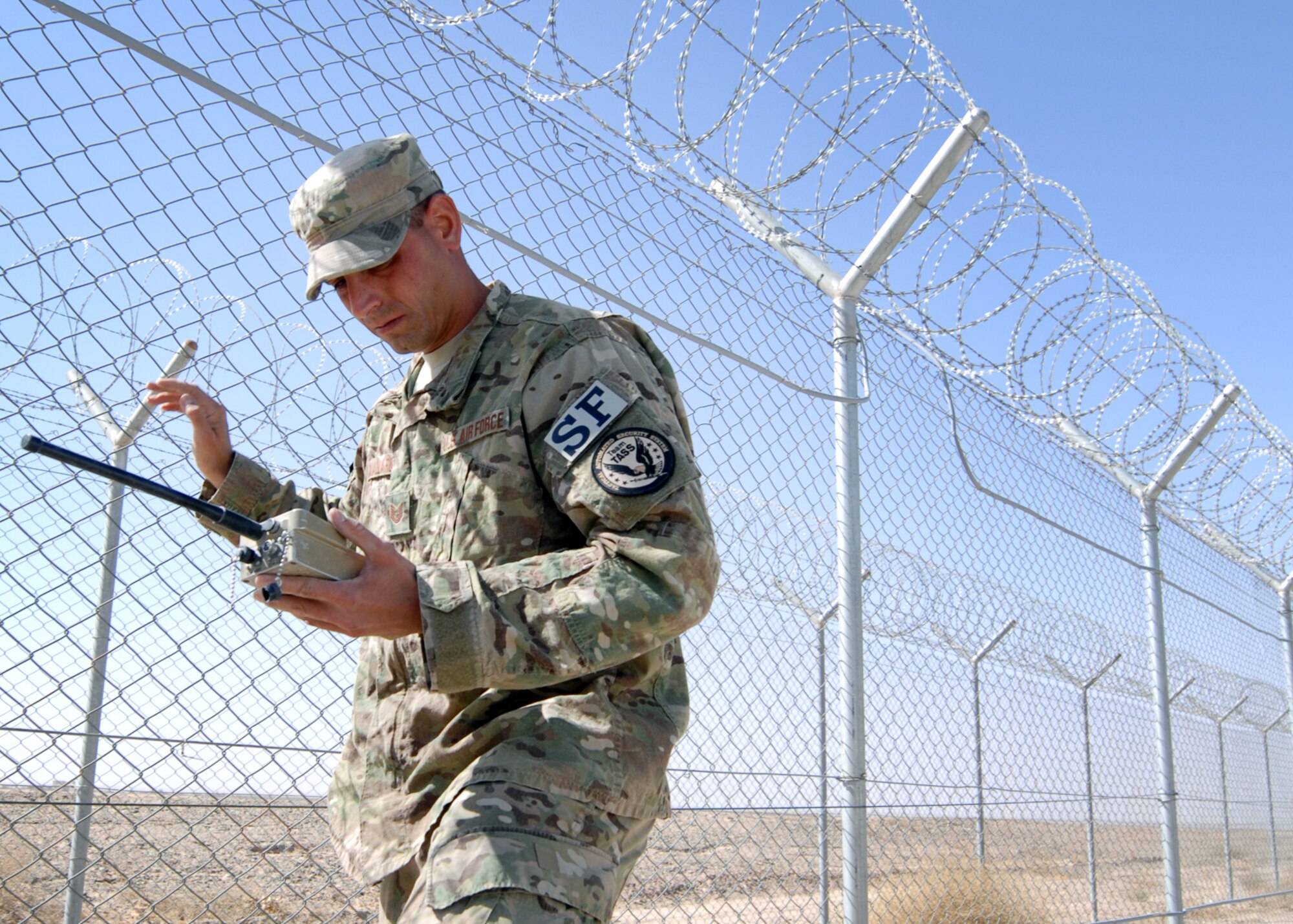 U.S. Air Force Tech Sgt. Joseph Cavallaro, 451st Expeditionary Security Forces Squadron tactical automated security system administrator, uses a handheld monitor to check the signal quality and strength of a security sensor at Kandahar Airfield.(U.S. Air Force photo/Master Sgt. Russell Martin/RELEASED)