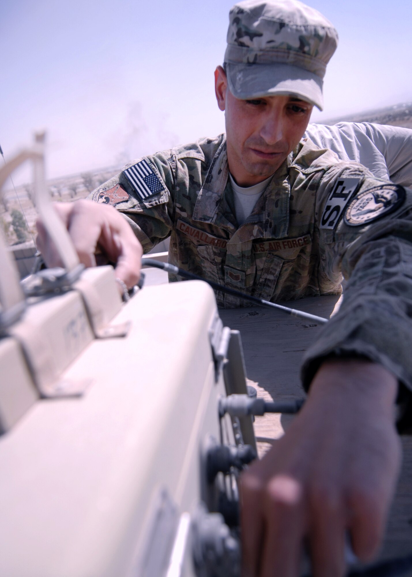 U.S. Air Force Tech Sgt. Joseph Cavallaro, 451st Expeditionary Security Forces Squadron tactical automated security system administrator, checks the sensor cable connection at one of the sensor towers here recently. Constant inspection and preventative maintenance of the TASS equipment ensures the system stays 100 percent operational at all times. (U.S. Air Force photo/Master Sgt. Russell Martin/RELEASED)