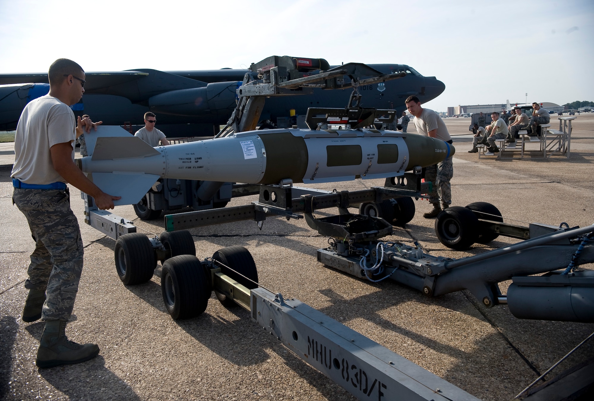 Airmen from the 20th Aircraft Maintenance Unit Viper 1 Load Crew guide an inert two-thousand pound GBU-31 bomb onto a lift during a competition on Barksdale Air Force Base, La., Sept. 28. Crews from the 20th AMU and 96th AMU loaded two bombs onto a B-52H Stratofortress while evaluators and spectators looked on. (U.S. Air Force photo/Staff Sgt. Chad Warren)(RELEASED)


