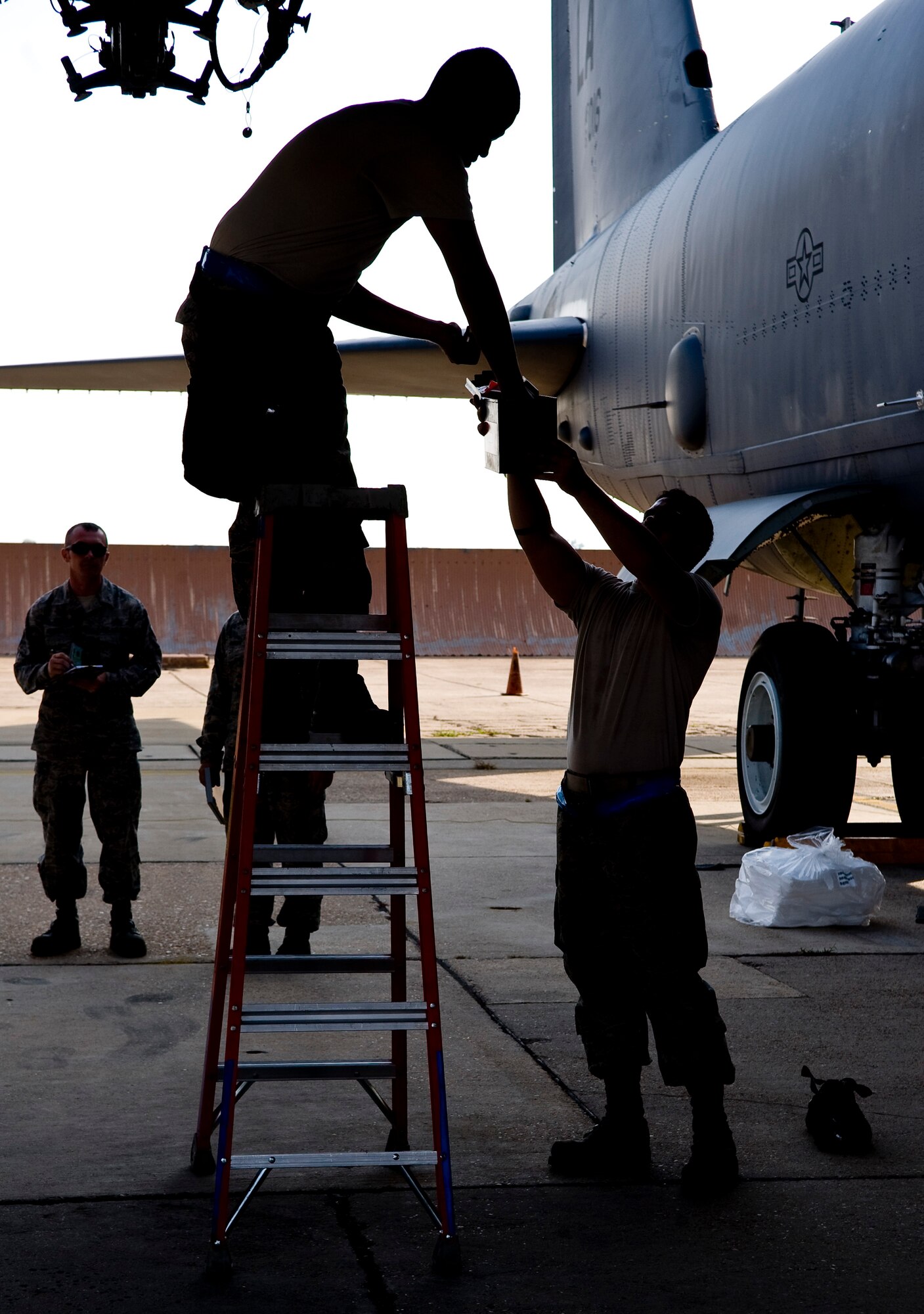 Senior Airmen Matthew Wallace (top) and Devin Borger, 20th Aircraft Maintenance Unit Viper 1 Load Crew members, prepare a heavy storage adapter beam to hold bombs on Barksdale Air Force Base, La., Sept. 28. The bomb load was part of a competition between load crews from the 20th AMU and 96th AMU. (U.S. Air Force photo/Staff Sgt. Chad Warren)(RELEASED)
