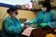 U.S. Air Force Capt. Jennilyn Estell, 20th Dental Squadron doctor of medical dentistry, hands an instrument over to Sunshine Maldanado, dental assistant, while working on patient, Tanya Maisonet, during a training exercise for the Red Cross Volunteer Dental Assistance Program, Shaw Air Force Base, S.C., Sept. 24, 2012. The Red Cross Dental Assistance Program offers dental education to military dependents and spouses, with over 900 hours of both classroom and hands-on training. (U.S. Air Force photo by Airman Hunter Brady/Released) 