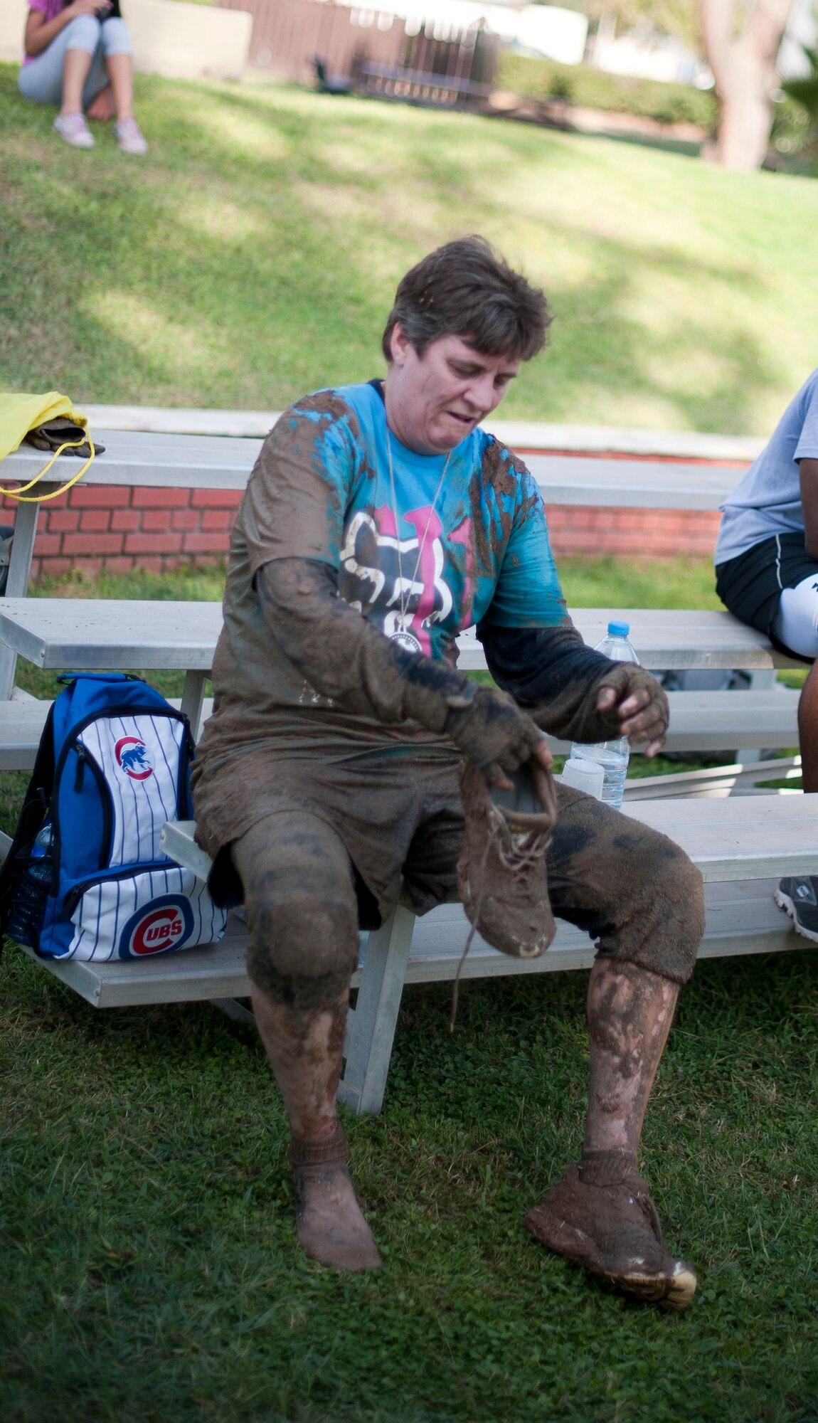 Nancy Judge, 39th Air Base Wing command chief, checks her shoes after finishing the Ultimate Dirty Dash II Sept. 29, 2012, at Incirlik Air Base, Turkey. The event was hosted by Incirlik's Top 3 to promote fitness and camaraderie, and to give the base community a chance to socialize and have fun. (U.S. Air Force photo by Senior Airman Clayton Lenhardt/Released)
