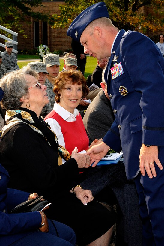 Col. Chris Crawford, 21st Space Wing commander, gives his appreciation to Elaine D. Mosburg, during the POW/MIA Recognition Day Sept. 21. Mosburg is the wife of Capt. Henry Lee Mosburg, who has been listed as MIA from the Vietnam War since 1966. (U.S. Air Force photo/Rob Bussard)