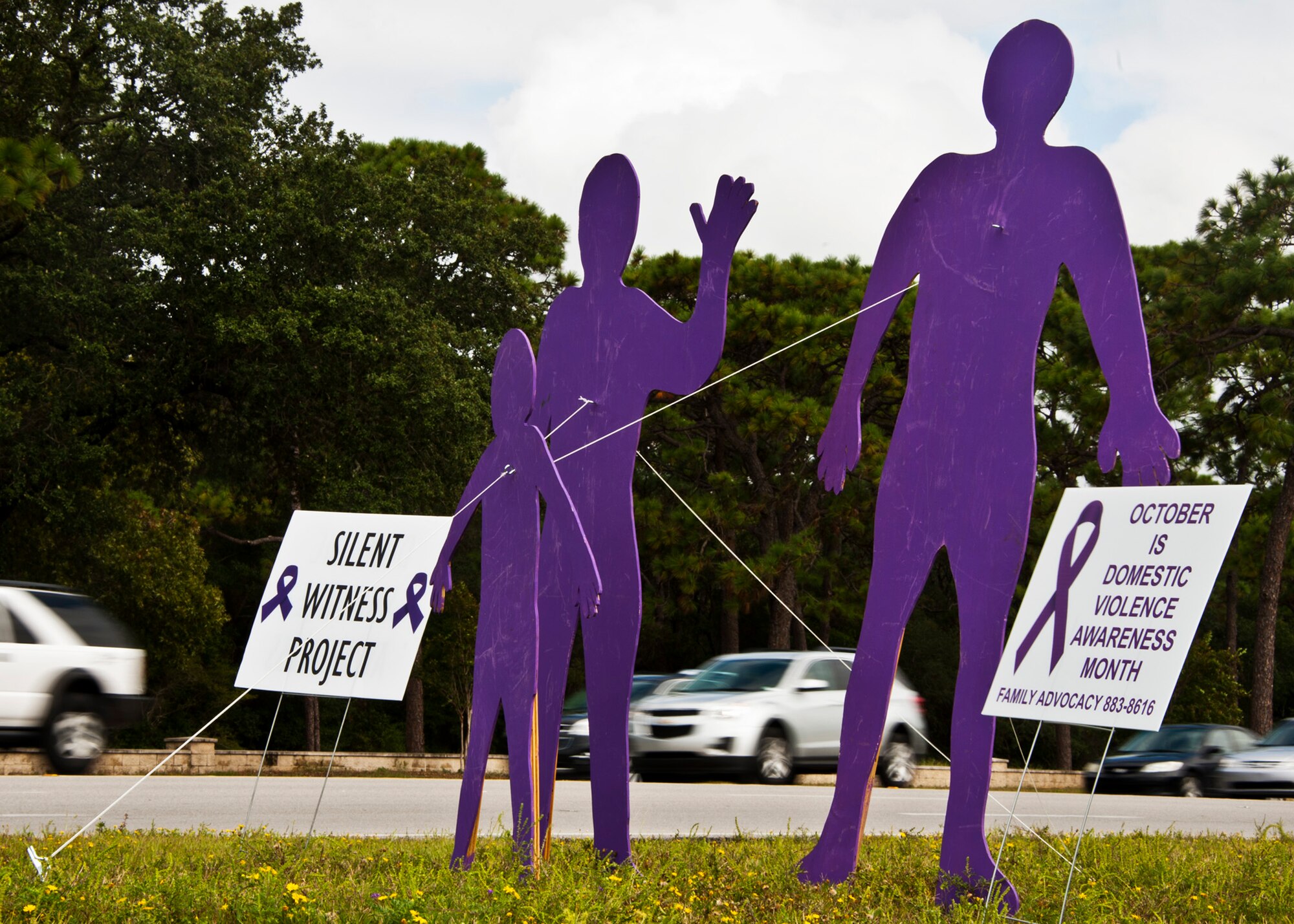 Team Eglin commuters entering and exiting the base may notice purple figures around the base. The exhibits were placed at both gates and the commissary by Family Advocacy for Domestic Violence awareness month. The three free-standing, life-sized figures are a variation on the Silent Witness project, established in 1991 and honors those who died as a result of domestic violence.  The purple people will greet commuters throughout October.  (U.S. Air Force photo/Sam King Jr.)
