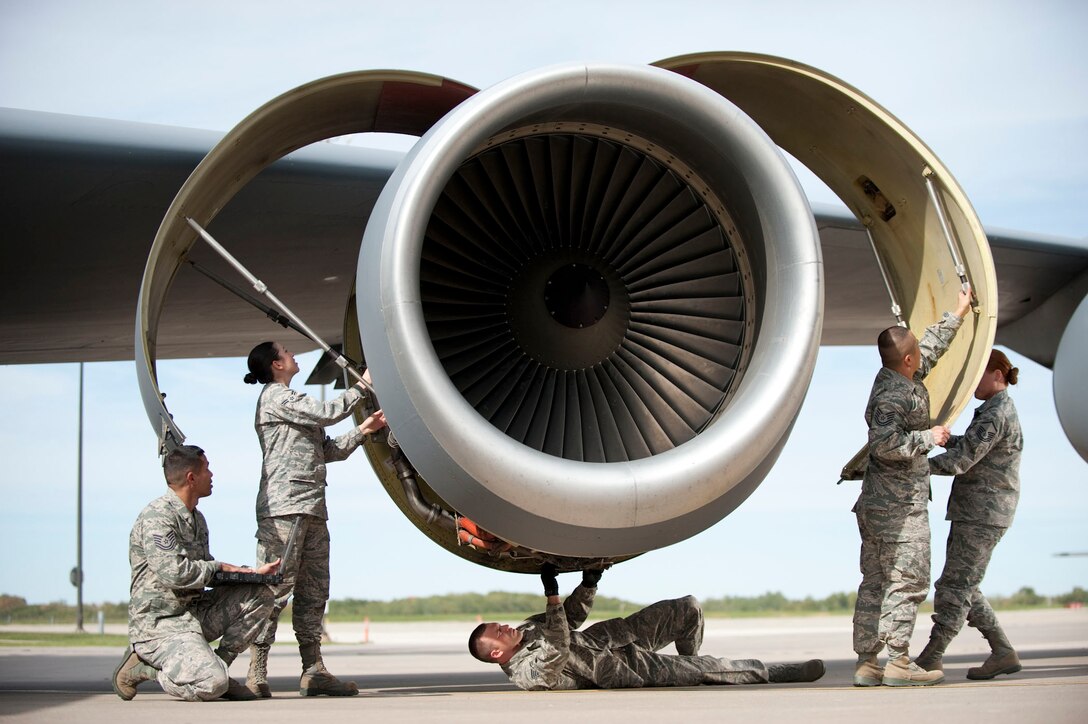 From left to right U.S. Air Force Tech. Sgt. Luis Quinones,  Airman 1st Class Samantha Palacios, Staff Sgt. Darrin Kesler, Tech. Sgt. Angelo Lino, and Master Sgt. Ashly Patterson simulate various maintenance functions on a KC-135 Stratotanker during filming for an Air National Guard commercial at the 182nd Airlift Wing in Peoria, Ill. on Sep. 27, 2012. (U.S. Air Force photo by Airman 1st Class Jon Alderman/Released.)