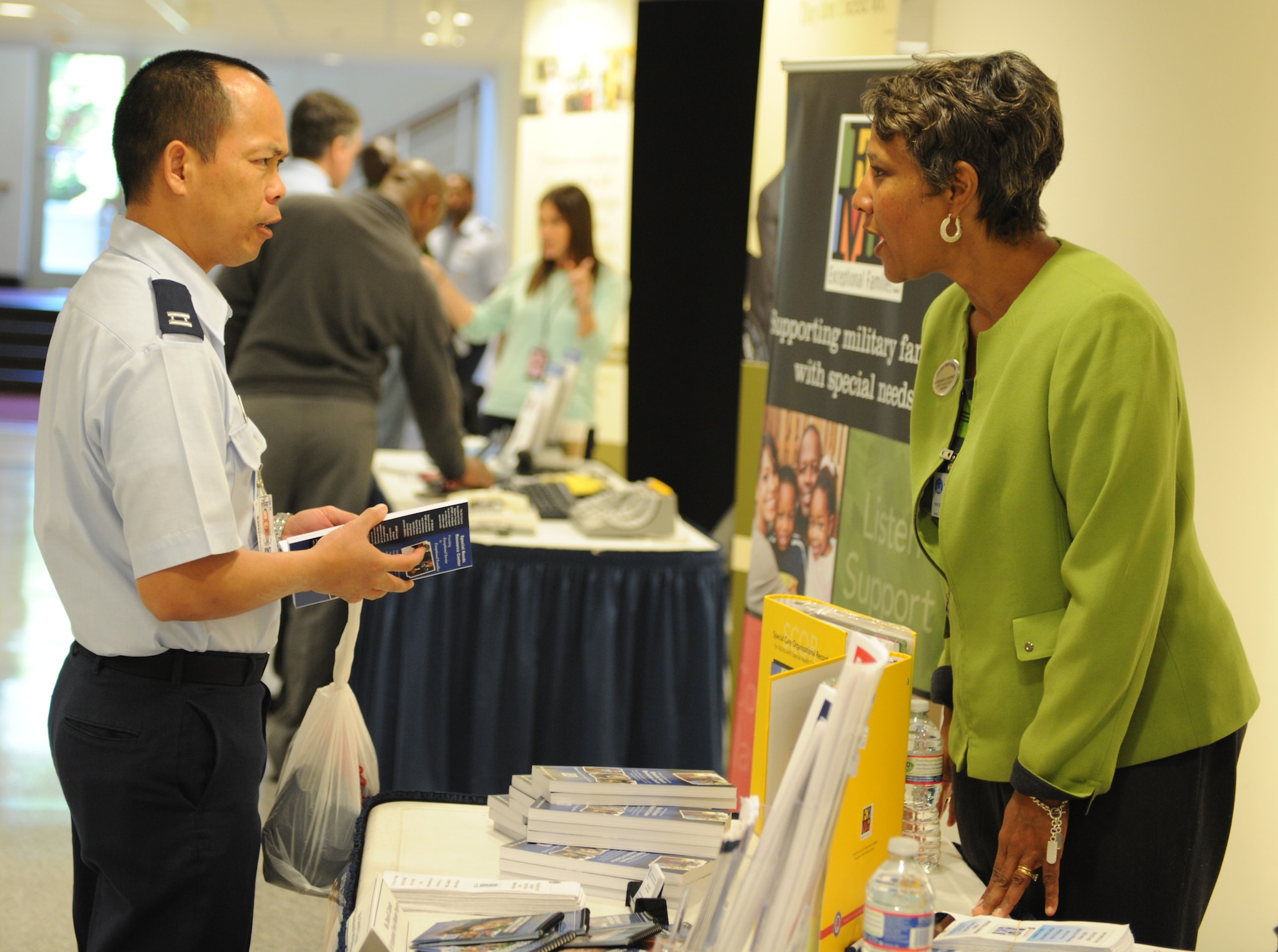 Adrienne Barnett speaks to Capt. Kevin Tran at an event held by the Headquarters Air Force to recognize National Disability Employment Awareness Month at the Pentagon on Oct. 1. The intent of the event was to educate Air Force employees and managers on various aspects of Disability Employment and Accommodations. Barnett is an Exceptional Family Member Program family support specialist and Tran is the chief of Force Support Readiness Plans with the Force Support Readiness Division. (U.S. Air Force photo/Senior Airman Christina Barlow)