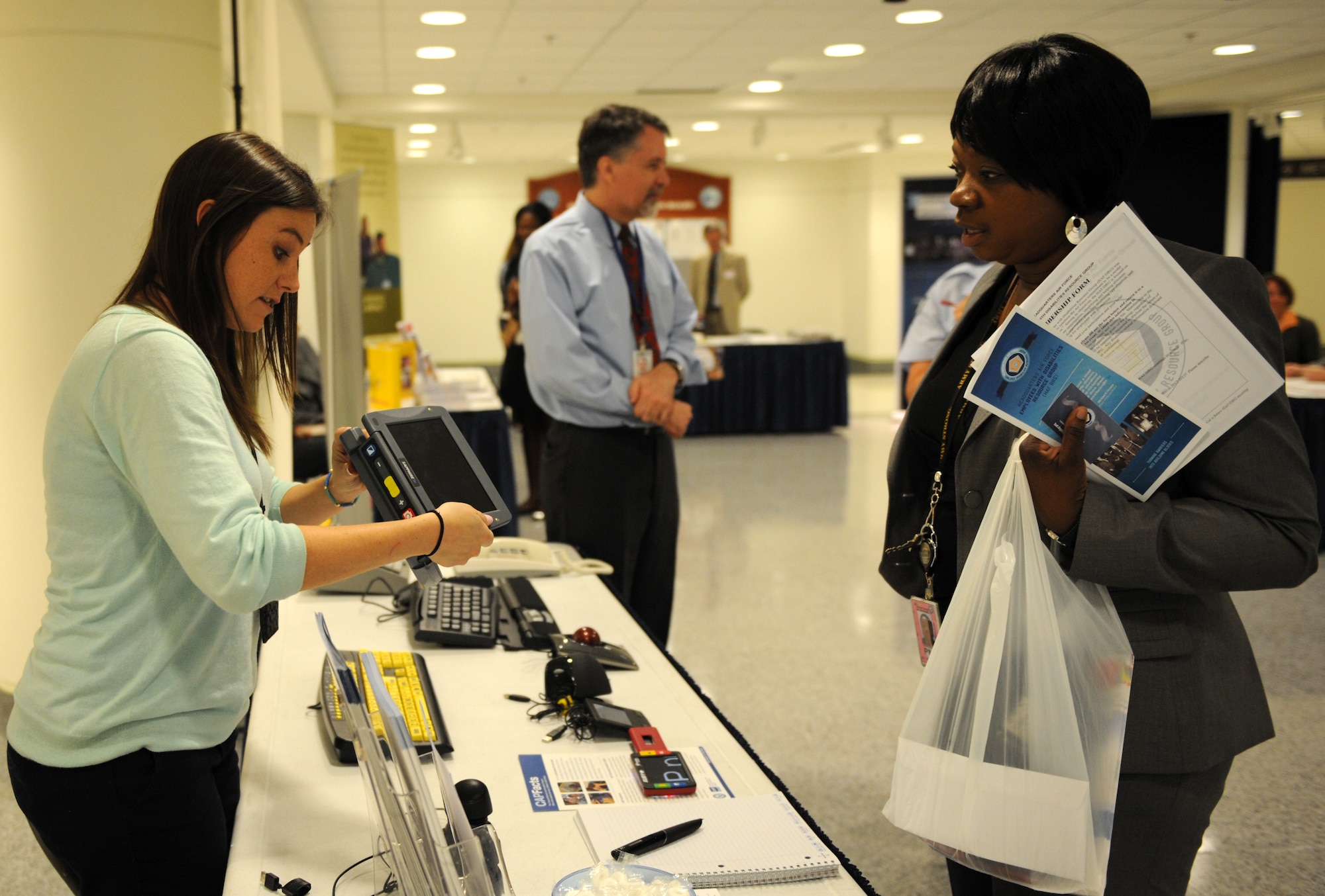 Erin Anderson demonstrates a product to Veronica Hayes at an event held by the Headquarters Air Force to recognize National Disability Employment Awareness Month at the Pentagon on Oct. 1. The intent of the event was to educate Air Force employees and managers on various aspects of Disability Employment and Accommodations. Anderson is a Computer/Electronic Accommodations Program (CAP) technical coordinator and Hayes is a base supply center assistant manager at Virginia Industries for the Blind. (U.S. Air Force photo/Senior Airman Christina Brownlow)