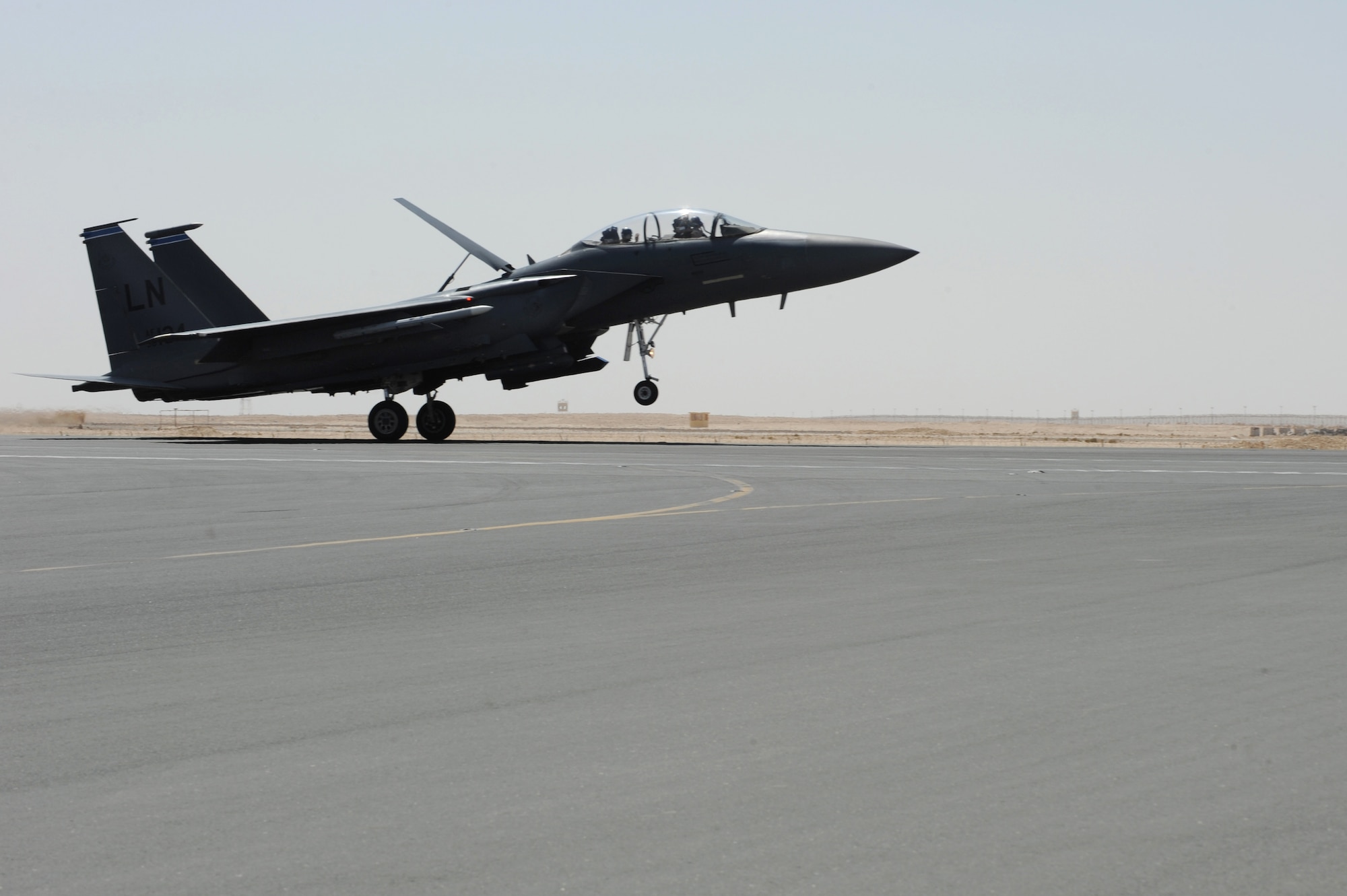 An F-15E Strike Eagle taxis down the runway after a touch-and-go landing maneuver at the 379th Air Expeditionary Wing, Southwest Asia, September, 26, 2012. The touch-and-go involves landing on a runway and taking off again without coming to a full stop allowing the pilot to master the landing. (U.S. Air Force photo/Staff Sgt. Sheila deVera)