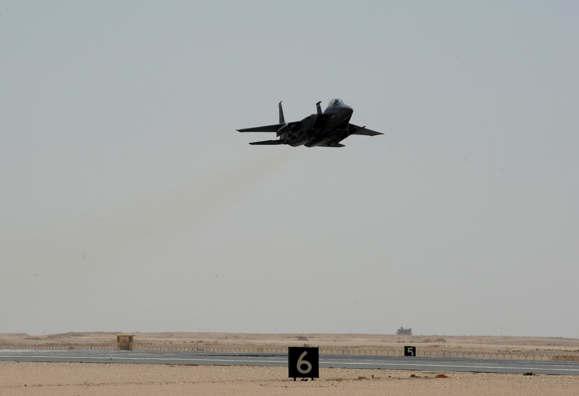 An F-15E Strike Eagle practices a touch-and-go landing maneuver at the 379th Air Expeditionary Wing, Southwest Asia, September, 26, 2012. The touch-and-go involves landing on a runway and taking off again without coming to a full stop allowing the pilot to master the landing. (U.S. Air Force photo/Staff Sgt. Sheila deVera)