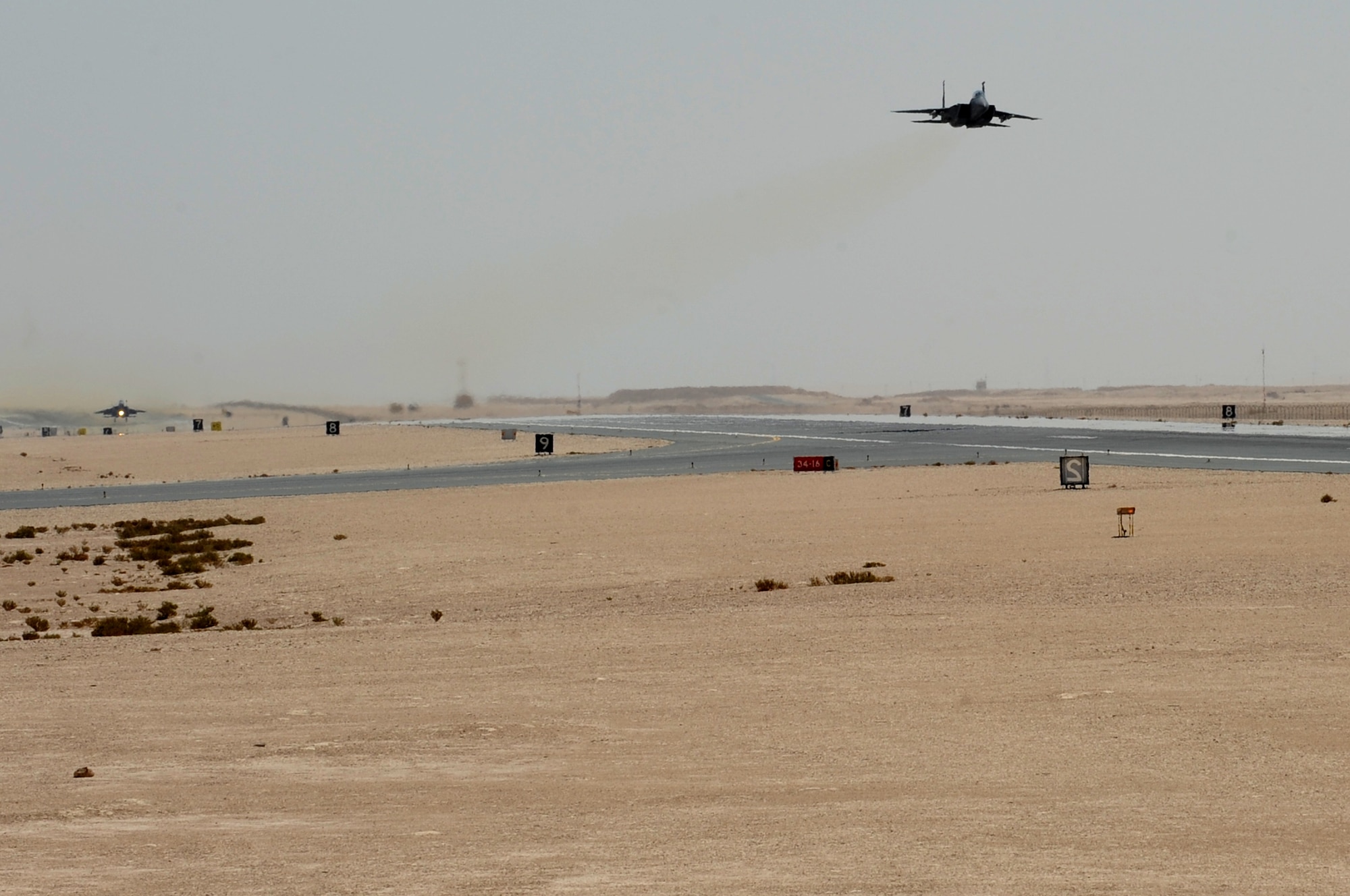 Two F-15E Strike Eagles takes-off during a touch-and-go landing exercise at the 379th Air Expeditionary Wing, Southwest Asia, September 26, 2012. The touch-and-go involves landing on a runway and taking off again without coming to a full stop allowing the pilot to master the landing. (U.S. Air Force photo/Staff Sgt. Sheila deVera)