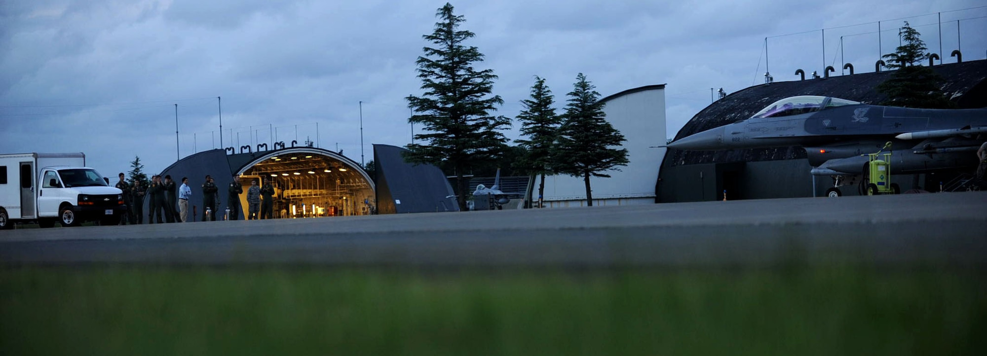 Pilots from the 13th and 14th Fighter Squadron watch as the last F-16 Fighting Falcon aircraft taxis to a hangar at Misawa Air Base, Japan, Sept. 26, 2012. The 35th Fighter Wing closed out the fiscal year flying program with more than 18,000 flying hours. (U.S. Air Force photo by Airman 1st Class Kenna Jackson)