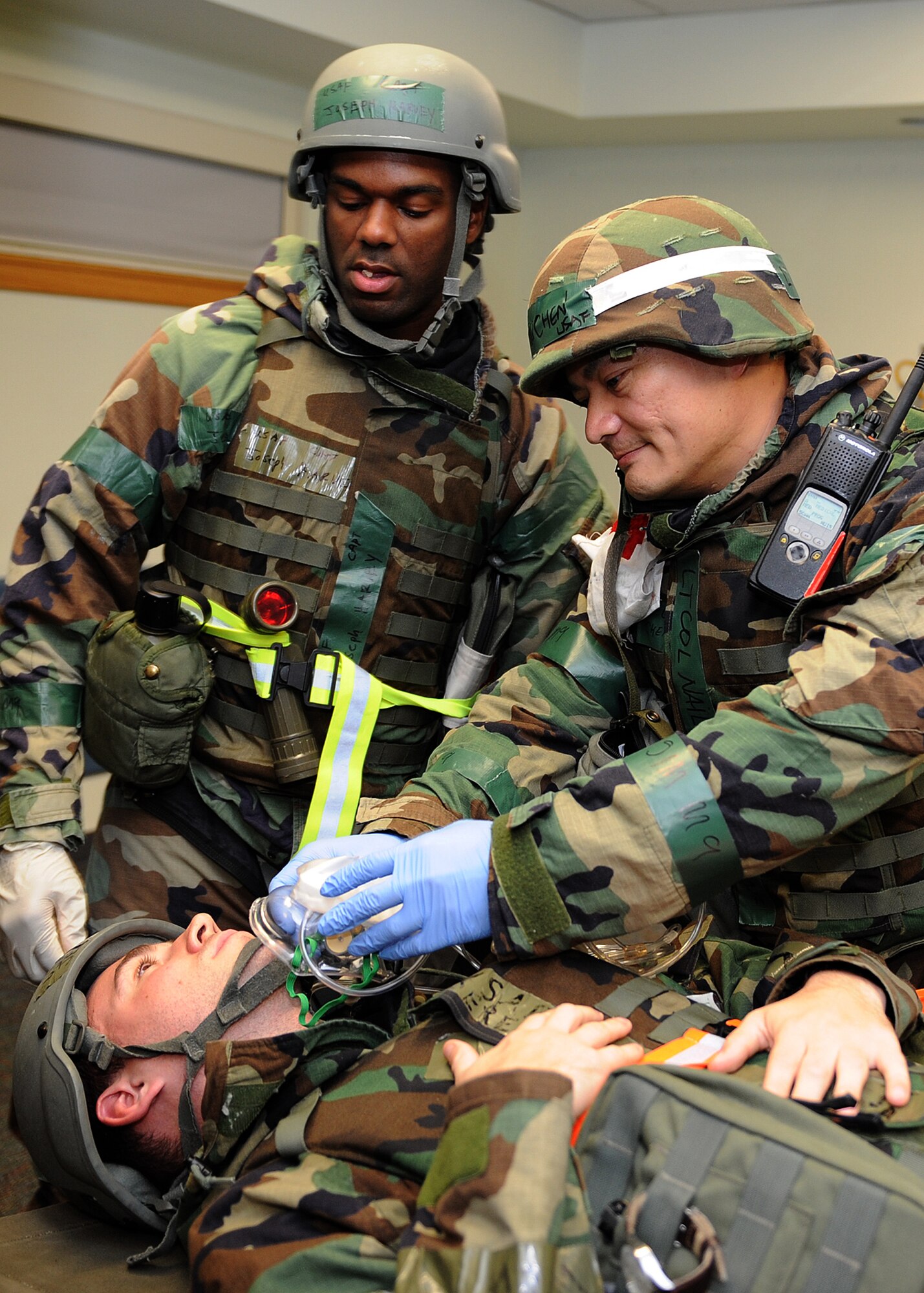 Capt. Joseph Harvey and Lt. Col. Naili Chen, both 8th Medical Operations Squadron, treat an injured military member following a simulated rocket attack during exercise Beverly Midnight 12-4 on Kunsan Air Base, Republic of Korea, Sept. 27, 2012. The exercise was designed to test the base readiness level during potential attack scenarios. (U.S. Air Force photo/Staff Sgt. Jonathan Fowler)