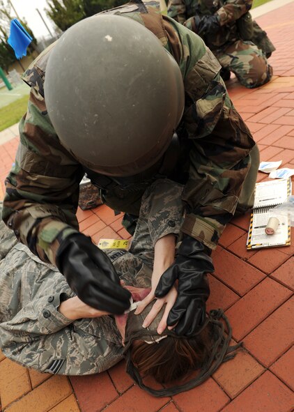Senior Airman Natasha Ashley, 8th Force Support Squadron, treats the simulated wounds of a role player during exercise Beverly Midnight 12-4 on Kunsan Air Base, Republic of Korea, Sept. 27, 2012. The exercise was designed to test the base readiness level during potential attack scenarios. (U.S. Air Force photo/Staff Sgt. Jonathan Fowler)