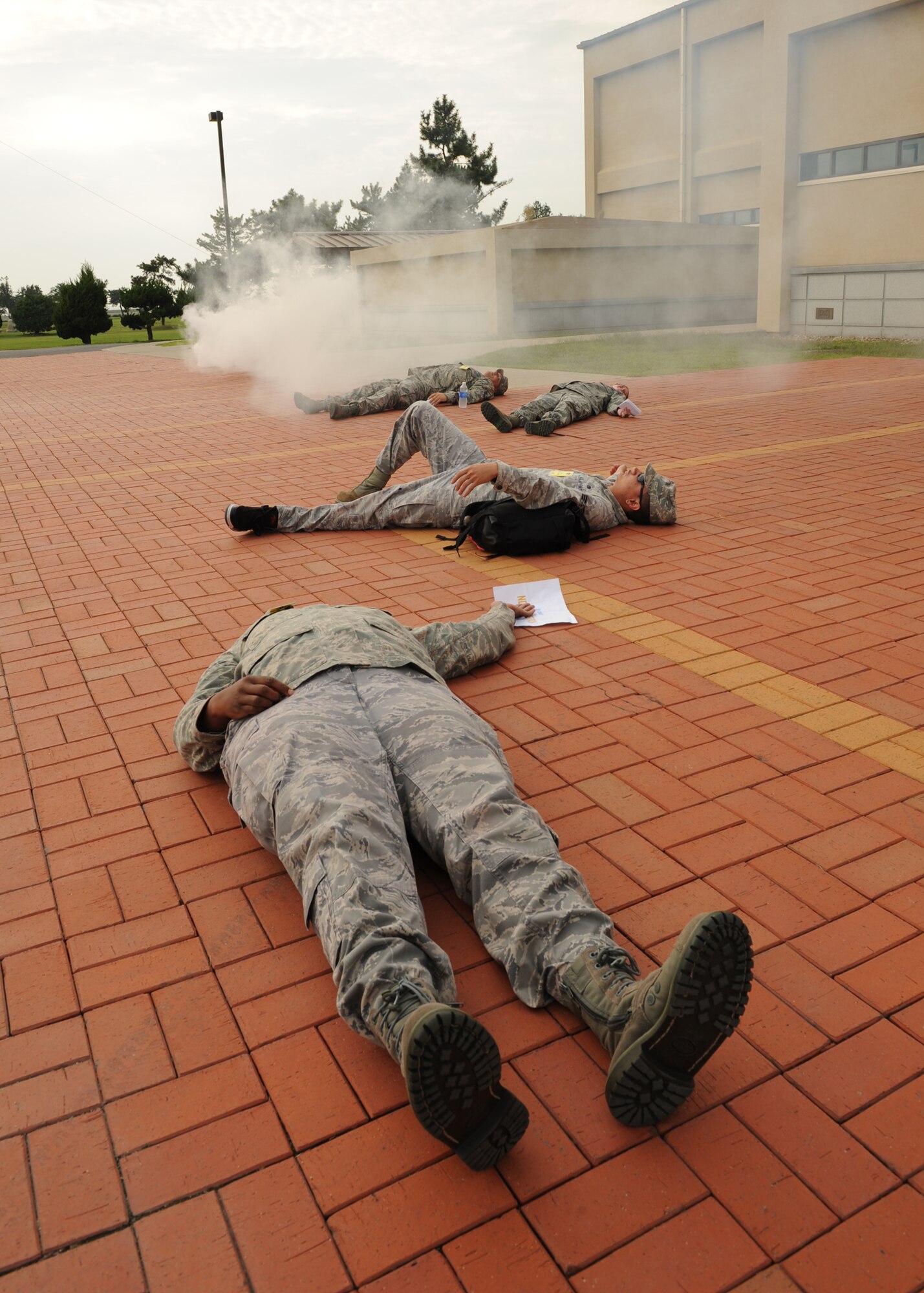 Role players react following a simulated rocket attack during exercise Beverly Midnight 12-4 on Kunsan Air Base, Republic of Korea, Sept. 27, 2012. Base members participate as role players during exercises to simulate what may happen to military members as a result of certain attacks in order to test emergency response actions.. (U.S. Air Force photo/Staff Sgt. Jonathan Fowler)