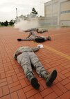Role players react following a simulated rocket attack during exercise Beverly Midnight 12-4 on Kunsan Air Base, Republic of Korea, Sept. 27, 2012. Base members participate as role players during exercises to simulate what may happen to military members as a result of certain attacks in order to test emergency response actions.. (U.S. Air Force photo/Staff Sgt. Jonathan Fowler)