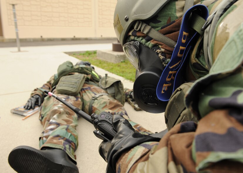 Senior Airman Mantalley Talley, 8th Force Support Squadron, reports Tech. Sgt. Tracy Love, 8th FSS, is suffering from simulated nerve-agent poisoning during exercise Beverly Midnight 12-4 on Kunsan Air Base, Republic of Korea, Sept. 27, 2012. The exercise was designed to test the base’s ability to respond to various types of attacks including chemical weapons attacks. (U.S. Air Force photo/Staff Sgt. Jonathan Fowler)