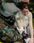 Technical Sergeant Lisa Slater 8th Operations Support Squadron, stabilizes a simulated wound on Senior Airman Megan Steen, 8th Force Support Squadron, during an exercise at Kunsan Air Base, Republic of Korea, Sept. 27, 2012. The exercise allowed Airmen to test their unit readiness. (U.S. Air Force photo/Senior Airman Marcus Morris)