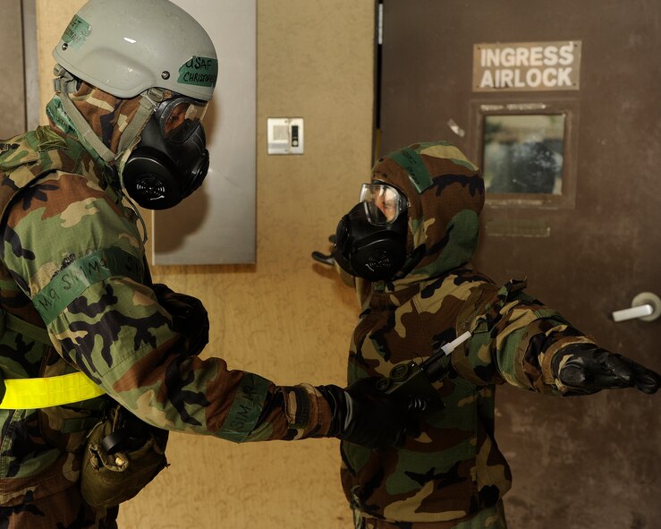 Technical  Sergeant Christopher Buckman 8th Civil Engineer Squadron, uses a chemical agent detector to make sure Tech. Sgt. Editha Vasquez is free from contamination before being allowed inside a dormitory building   at Kunsan Air Base, Republic of Korea, Sept. 27, 2012 during an exercise. Airmen exercise contingency responses to ensure compliance and readiness. (U.S. Air Force photo/Senior Airman Marcus Morris)