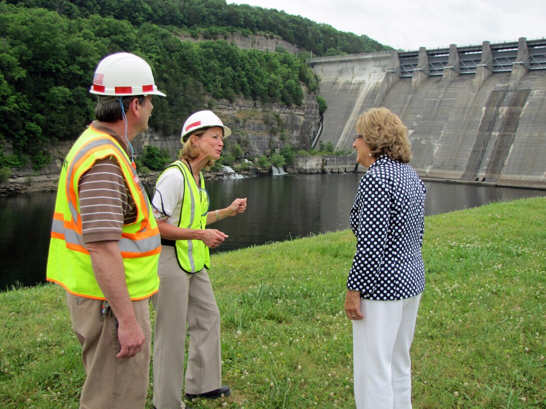 David Loyd (Left), Center Hill Dam Foundation Remediation Project resident engineer, looks on as Linda Adcock (Center), project manager, discusses the seepage around the right rim of the dam with U.S. Rep Diane Black, Tennessee District 6.  The right rim is in the background between Adcock and Black. (USACE photo by Bill Peoples)