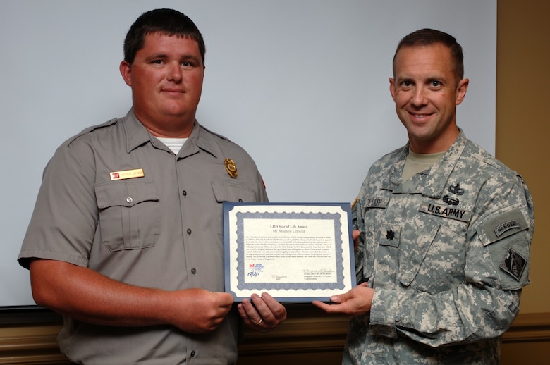 Lt. Col. James A. DeLapp (Right), U.S. Army Corps of Engineers Nashville District commander, presents the "LRD Star of Life Award" on behalf of the Great Lakes and Ohio River Division commander during a ceremony in Nashville, Tenn., June 11, 2012 to Park Ranger Matthew Leftwich, J. Percy Priest Lake.  The award recognized Leftwich for rescuing a struggling swimmer.  The Nashville District also named him the employee of the month for April 2012 for his heroic actions and outstanding work as a park ranger. (USACE photo by Lee Roberts)