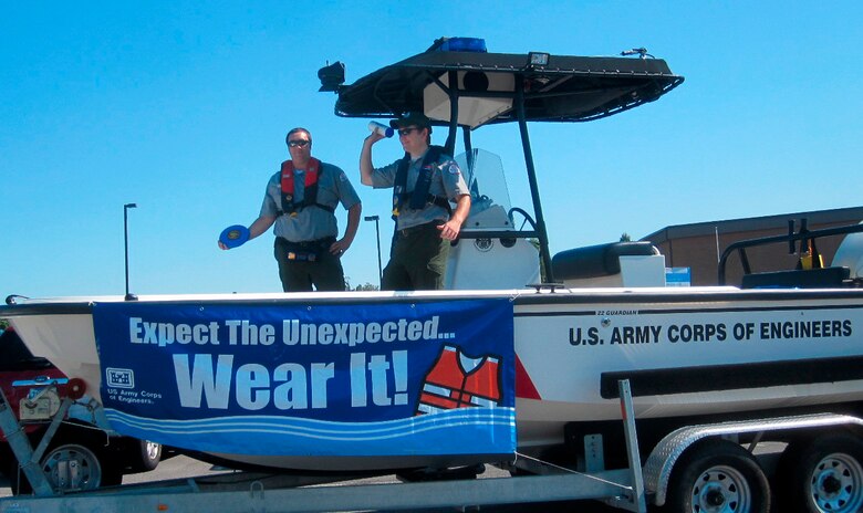 Lake Barkley Park Rangers Dylon Anderson(Left) and Cody Britton handout water safety promotional items to the public at a local community parade.