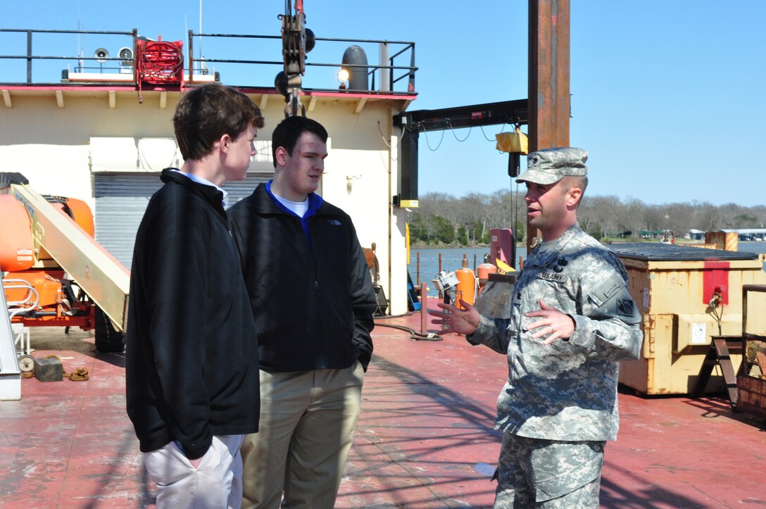 Lt. Col. James A. DeLapp (Right), U.S. Army Corps of Engineers Nashville District commander, shows Montgomery Bell Academy students Will Singer (Left) and D. J. Mott a Corps of Engineer's work barge at Old Hickory Lake March 9, 2012. (USACE photo by Amy Redmond)