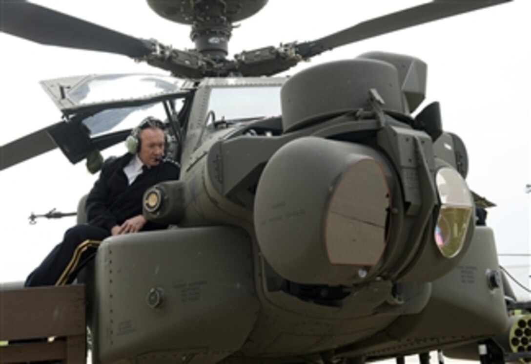Chairman of the Joint Chiefs of Staff Gen. Martin E. Dempsey peers into the cockpit as he receives a brief on the capabilities of the Apache Block 3 helicopter during a visit to Fort Riley, Kan., on Oct. 1, 2012.  