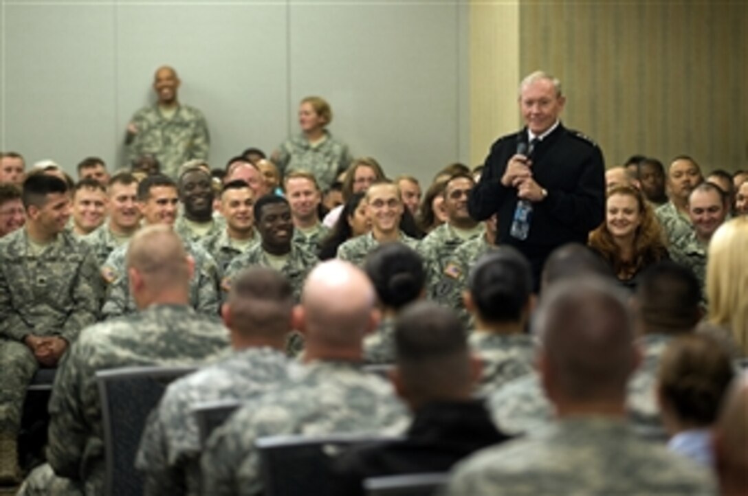 Chairman of the Joint Chiefs of Staff Gen. Martin E. Dempsey answers questions from the audience at a town hall meeting with military families and DoD civilians during a visit to Fort Riley, Kan., on Oct. 1, 2012.  