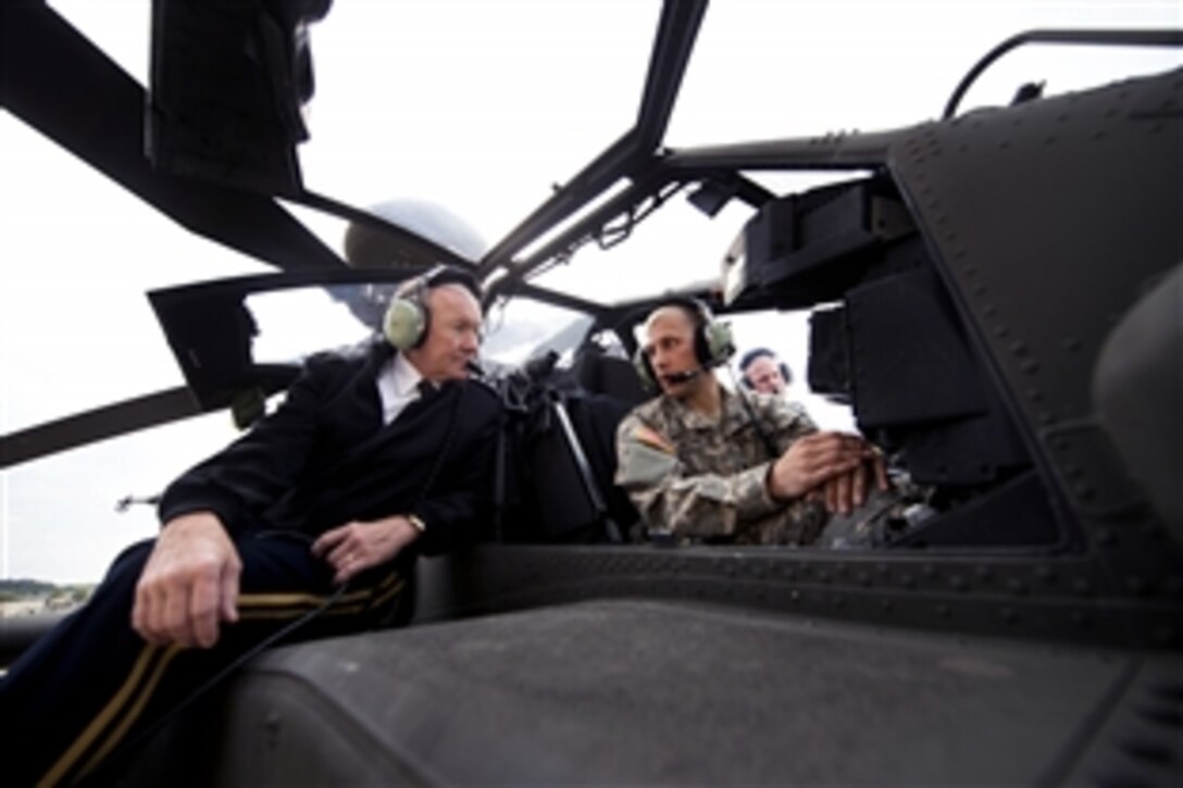 Army Gen. Martin E. Dempsey, chairman of the Joint Chiefs of Staff, receives a briefing on the capabilities of the AH-64D Apache Longbow Block III helicopter during a visit to Fort Riley, Kan., Oct. 1, 2012.