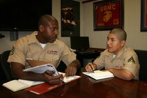 QUANTICO, Va. -Staff Sergeant Jelani Nix (left), Marine Corps Systems Command’s Training Chief, discusses Corporal Rodolfo Estrada’s folder with the Staff Secretary Administration Corporal., Bill Johnson-miles, 9/28/2012 10:44 AM
