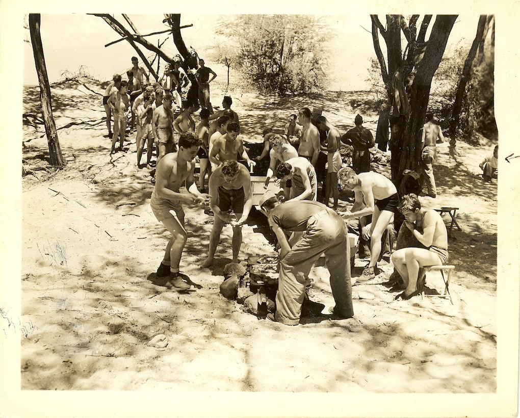 "I am sitting at extreme right. Talking to some lad. This is the line for food - you can see the burgers being cooked & some of the lads reaching for bread, etc."