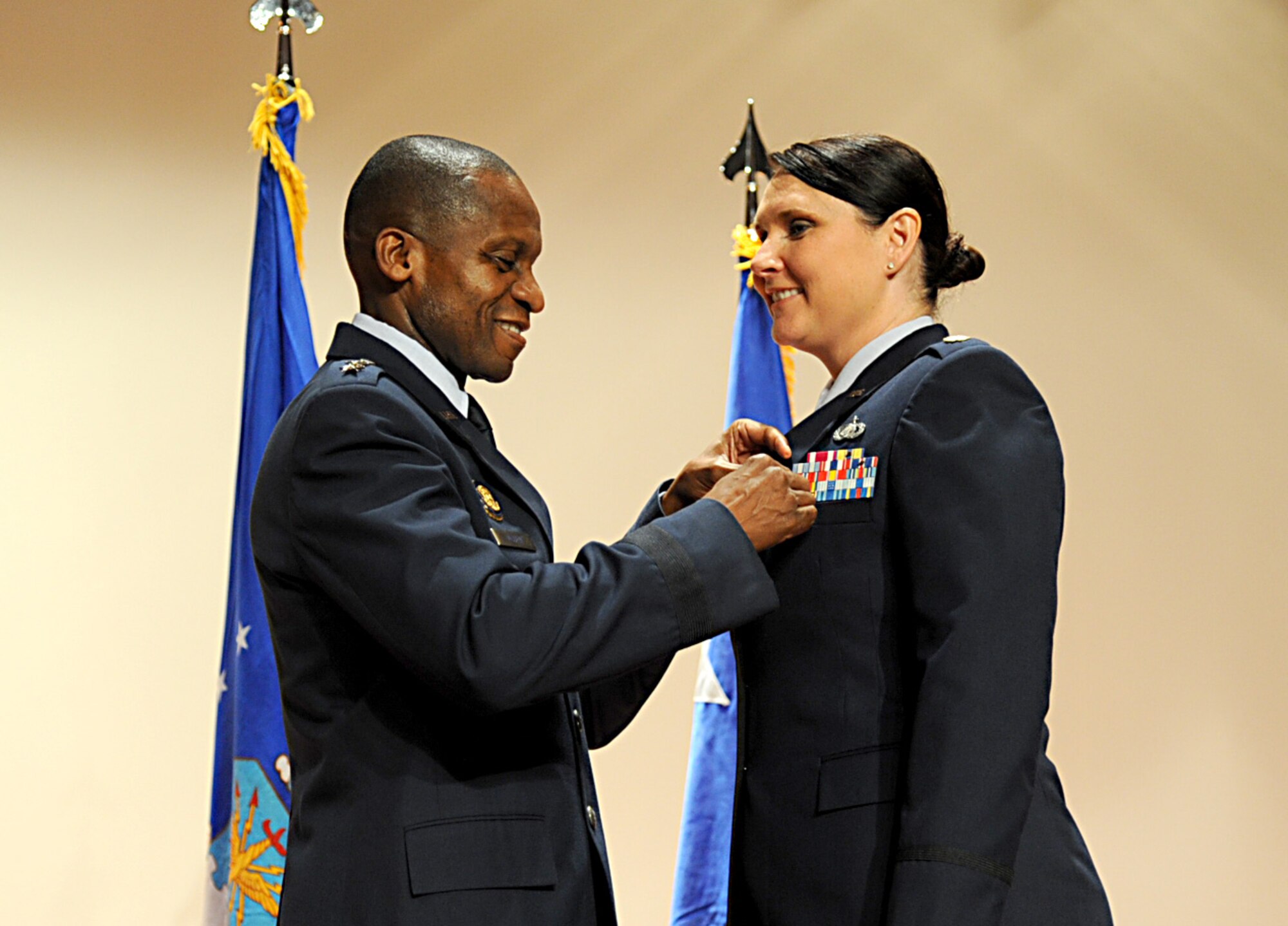 Lt. Gen. Darren McDew, 18th Air Force commander, present the Bronze Star to Maj. Heather Sullivan during the commanders call at the base theater Sept. 28 at Scott Air Force Base, Ill. The Bronze Star is the fourth highest combat decoration; it’s awarded for acts of heroism, acts of merit, or meritorious service in a combat zone. (U.S. Air Force photo/ Senior Airman Tristin English)