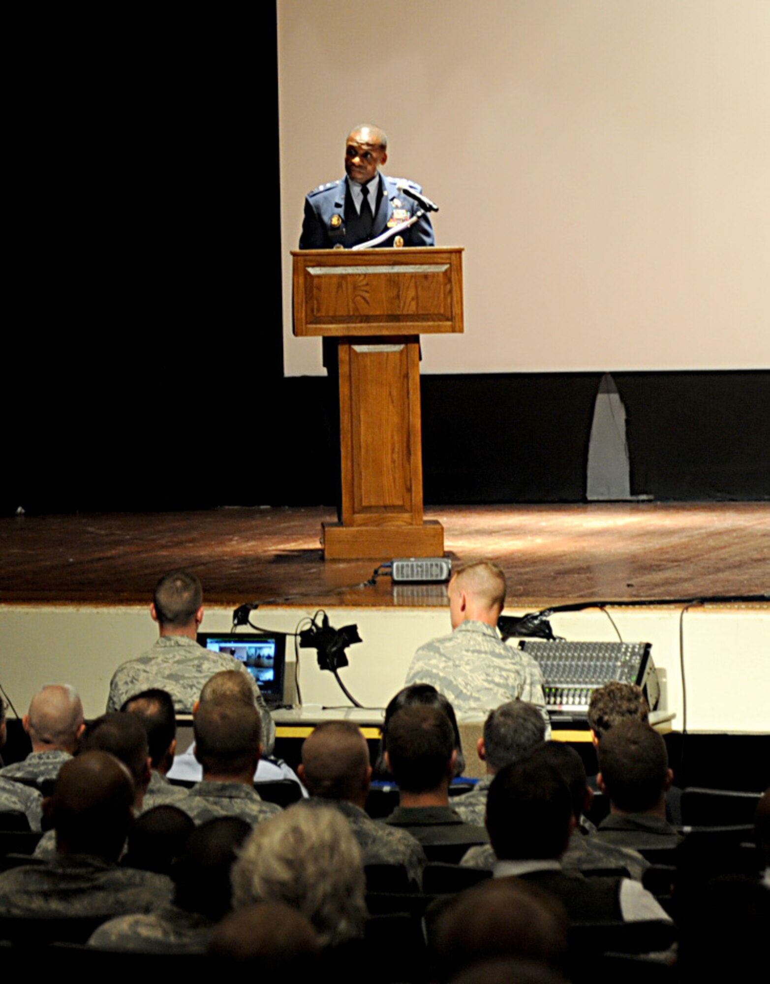 Lt. Gen. Darren McDew, 18th Air Force commander, speaks to Airmen during a commanders call at the base theater Sept. 28 at Scott Air Force Base, Ill. McDew spoke about how we all need to take care of each other and thanked them for all that they have accomplished and will accomplish in the future. (U.S. Air Force photo/ Senior Airman Tristin English)