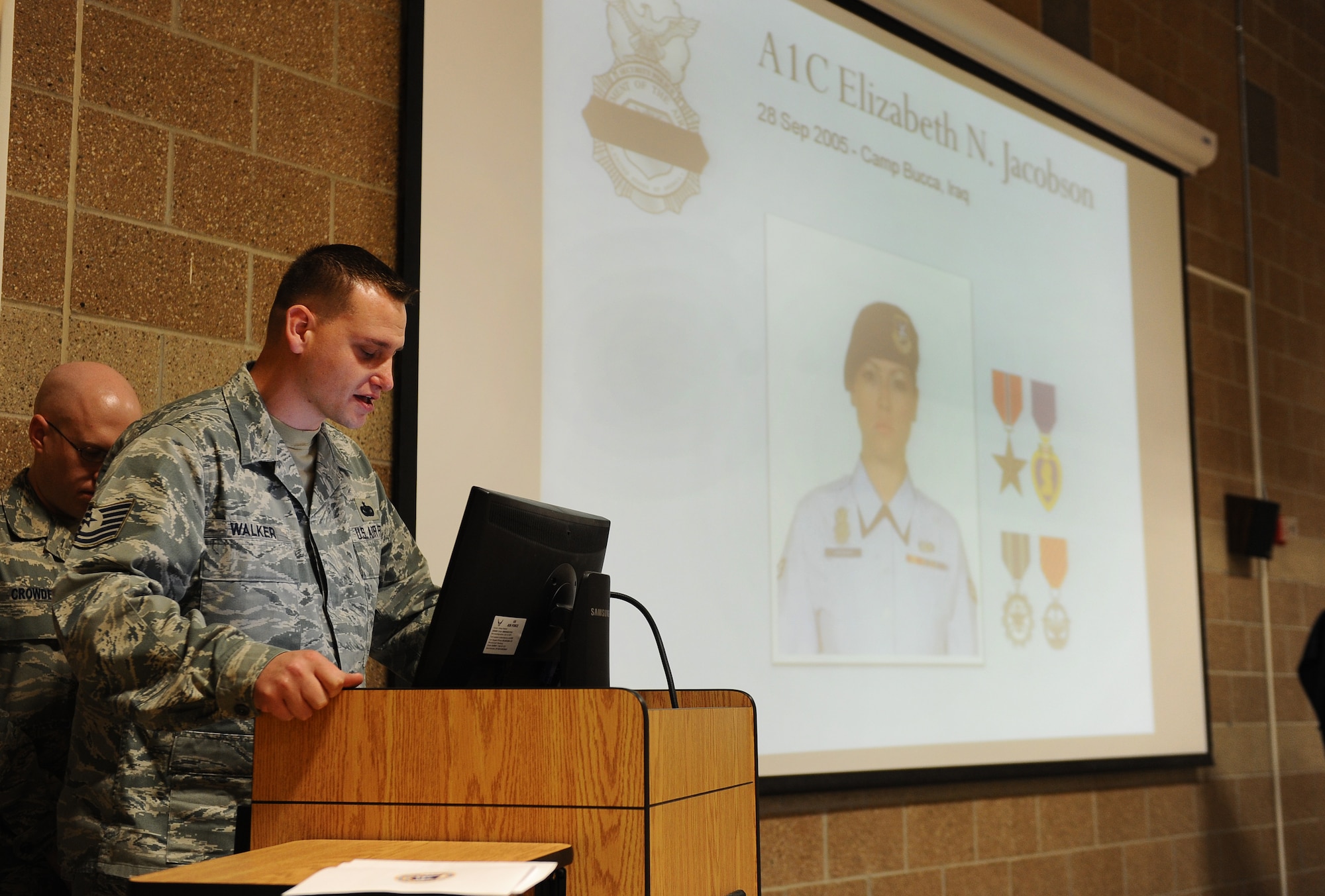 U.S. Air Force Tech. Sgt. Dennis Walker, 55th Security Forces Squadron, gives insight on the type of person the late U.S. Air Force Airman 1st Class Elizabeth Jacobson was at the annual Fallen Defenders and Master at Arms Dedication Ceremony held at the guard mount room of the 55th SFS headquarters building on Offutt Air Force Base, Neb., Sept. 28.  Jacobson lost her life while on tour in Iraq.  (U.S. Air Force Photo by Josh Plueger/Released)