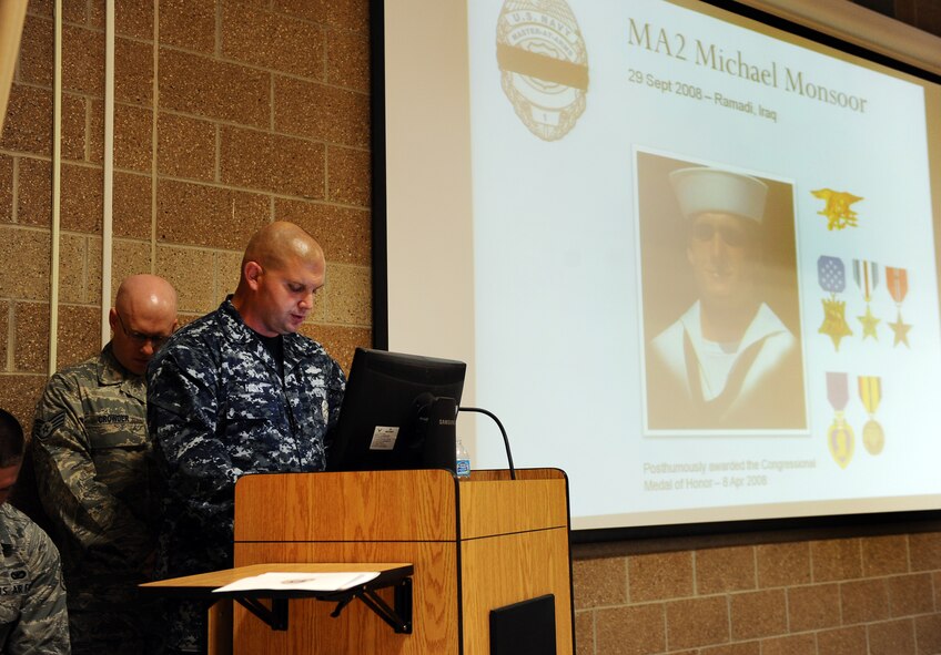 U.S. Navy Master at Arms 1st Class Marc Hicks, 55th Security Forces Naval detachment speaks about Michael Monsoor who died in combat in Ramadi, Iraq, in 2008, at the 2012 Fallen Defenders and Master at Arms dedication ceremony held in the guard mount room of the 55th SFS headquarters building on Offutt Air Force Base, Neb., Sept. 28.  The dedication ceremony is held annually to honor the sacrifices the men and women of the security forces career field have made in support of Operations ENDURING FREEDOM and IRAQI FREEDOM.  (U.S. Air Force photo by Josh Plueger/Released).