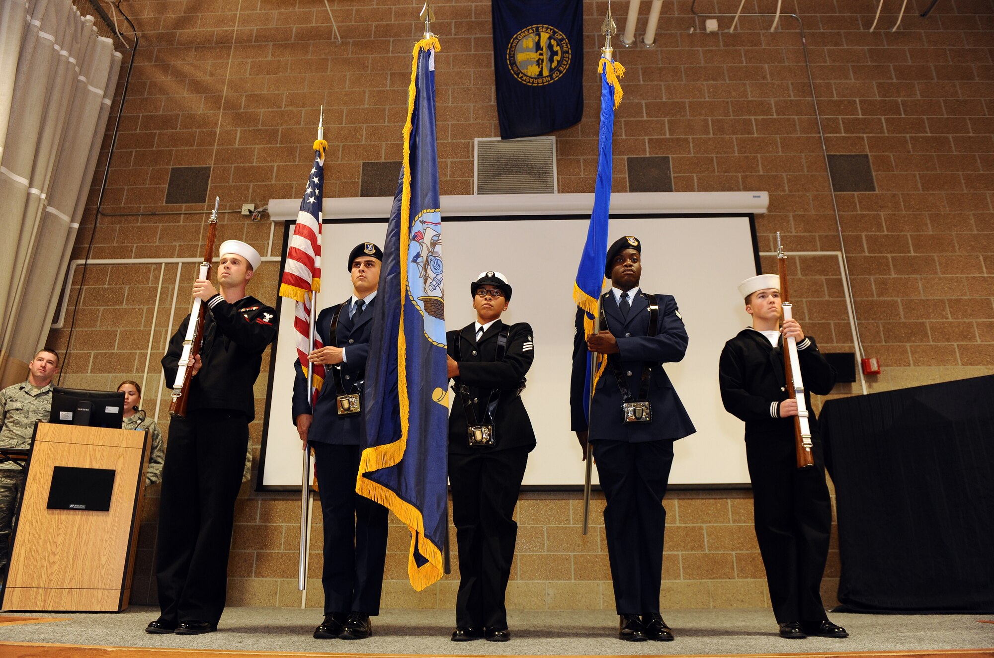 A color guard made up of Sailors and Airman from the 55th Security Forces Squadron post the colors at a memorial service held in the guard mount room of the 55th SFS building on Offutt Air Force Base, Neb., Sept. 28.  The annual memorial service honors those who’ve given all during Operations ENDURING FREEDOM and IRAQI FREEDOM.  Several family members were also in attendance to unveil a memorial dedicated to their lost loved ones.  (U.S. Air Force photo by Josh Plueger/Released)