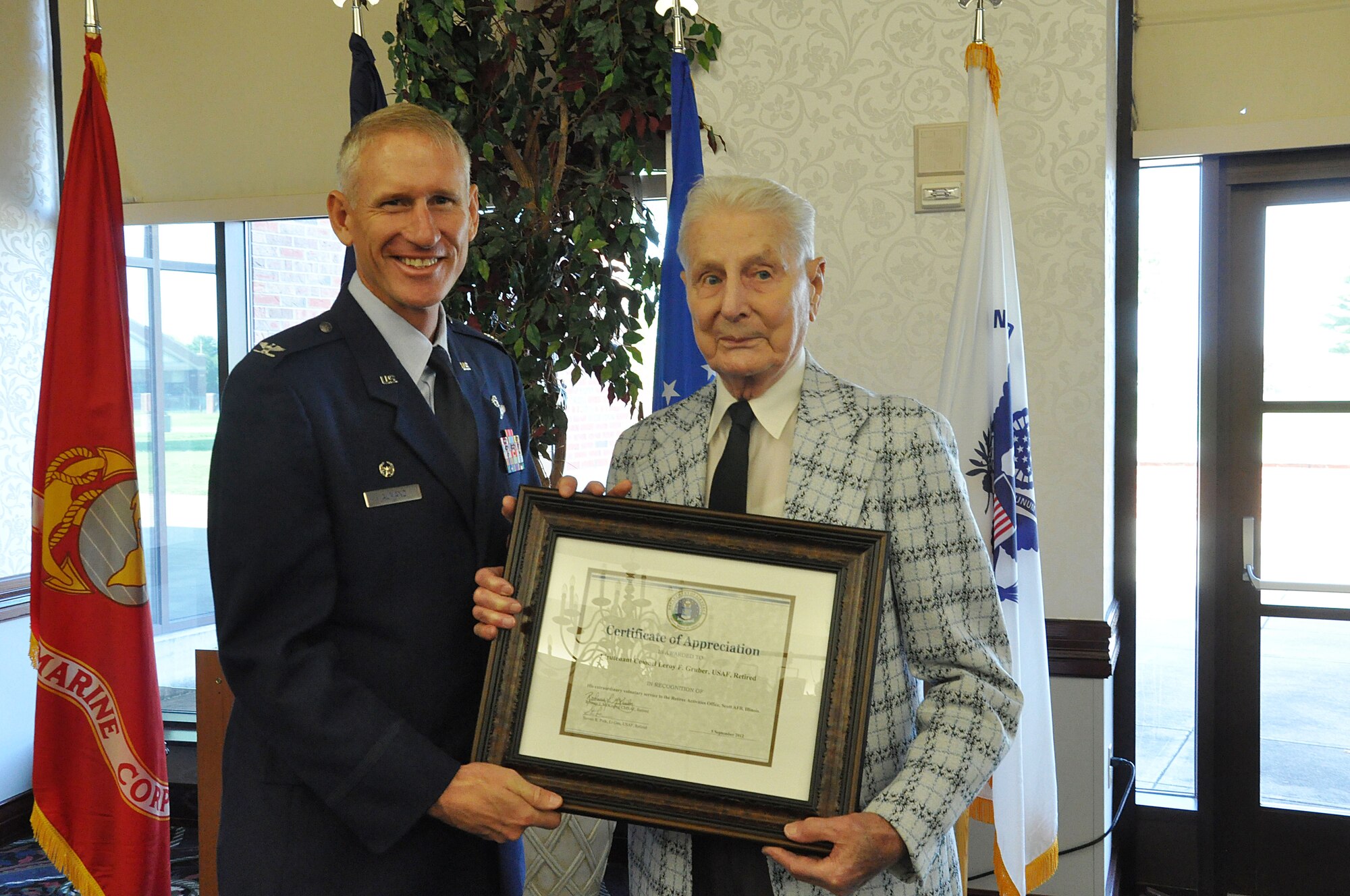 – Col. David Almand, 375th Air Mobility Wing commander presents retired Lt. Col. Leroy Gruber with the volunteer of the year award at the Scott Club at Scott Air Force Base, Ill. Sept. 28, 2012. Gruber received the award for the positive impact he has had on the morale and welfare of base personnel as well as serving the more than 23,000 military retirees living in the greater Scott Air Force Base and surrounding communities that encompass Southern Illinois, Eastern Missouri, Southern Indiana and Western Kentucky who have benefited from his volunteer service and commitment. (U.S. Air Force photo/Airman 1st Class Jake Eckhardt)