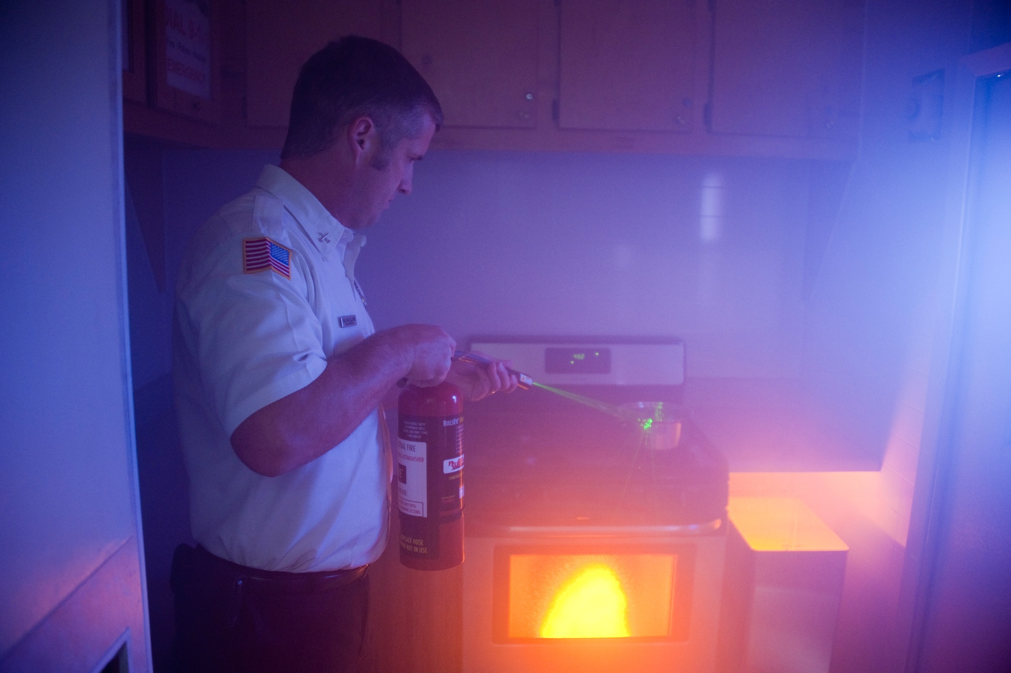 Hal McLLend, Fire Inspector at Wichita Falls fire station simulates putting out a fire on top of the stove using a digital laser fire extinguisher. Fire Prevention Week has a weeklong list of activities for the entire family to prepare a plan of action in case of a fire on Oct. 2, 2012 (US Air Force Photo by Danny Webb) (Released)