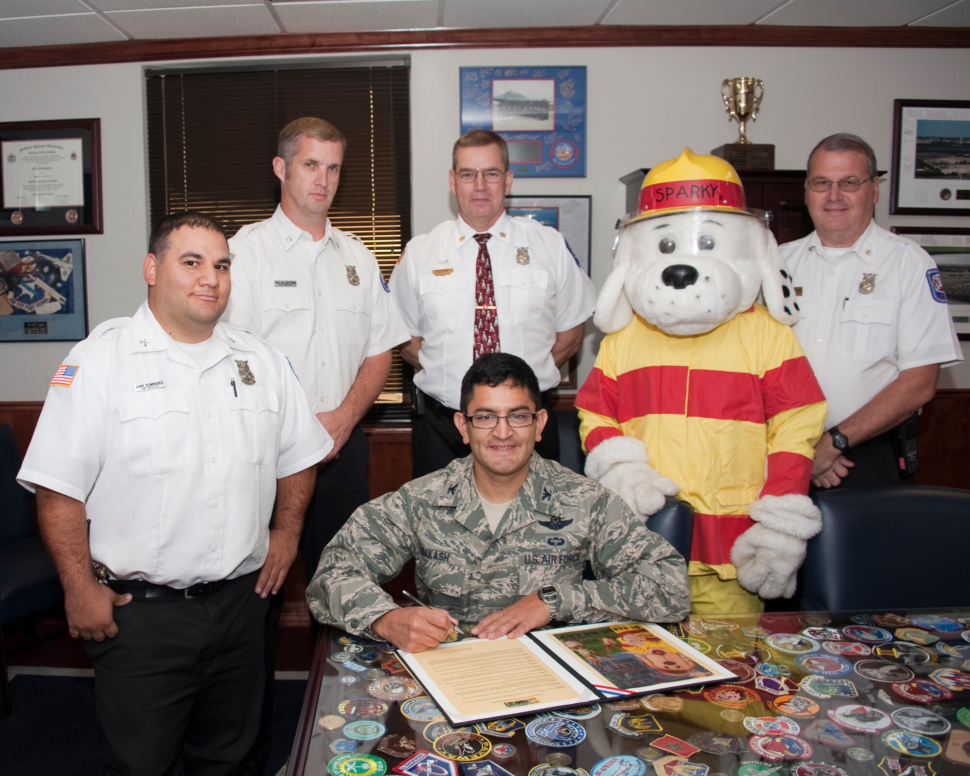 Col OM Prakash Vice Commander, 82nd Training Wing signs the Proclamation for Fire Prevention week along with the fire station staff and Sparky the fire dog. Signing this documents shows national support of fire departments as they teach fire safety in their community on Oct. 2, 2012 (US Air Force Photo by Danny Webb) (Released)