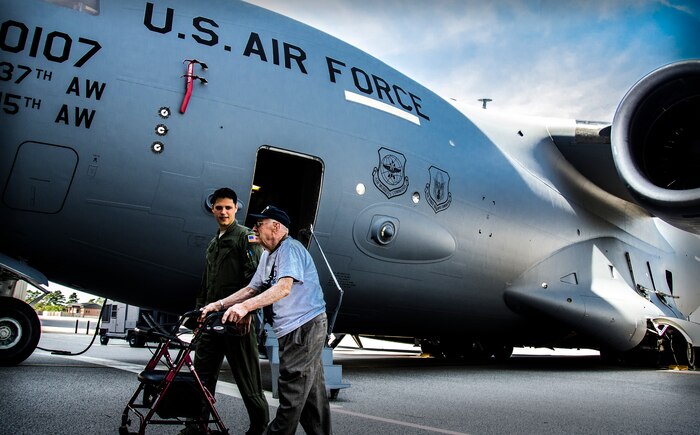 Captain Ben Peacock and Ralph Carter trade stories of their military careers after touring a C-17 Globemaster III Sept. 28, 2012, at Joint Base Charleston – Air Base. Peacock is a 15th Airlift Squadron C-17 pilot, 437th Airlift Wing, and Carter is a retired Marine Corps veteran and surviving member of the 437th Troop Carrier Group. (U.S. Air Force Photo / Airman 1st Class Tom Brading)