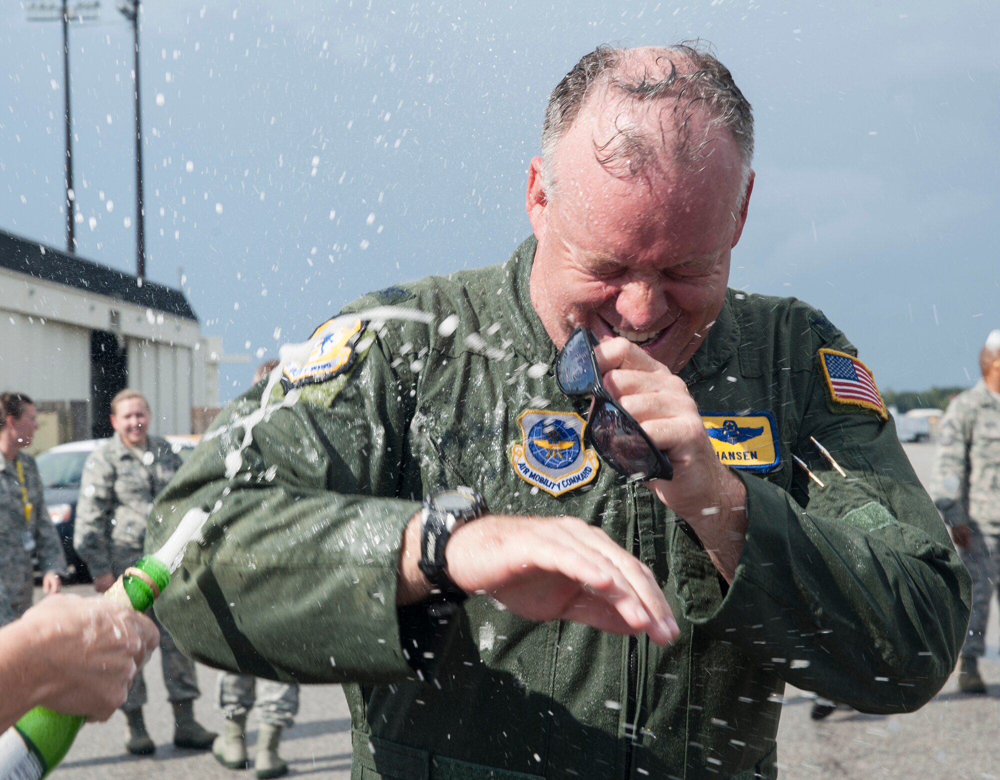 Col. Erik Hansen is sprayed with sparkling grape juice by his wife Susan after completion of his final flight as the 437th Airlift Wing commander at Joint Base Charleston - Air Base, S.C., Oct. 2, 2012. The final or "fini flight," is an aviation tradition in which aircrew members are met by their unit comrades, family and friends and soaked with water. (U.S. Air Force photo/ Airman 1st Class Ashlee Galloway)