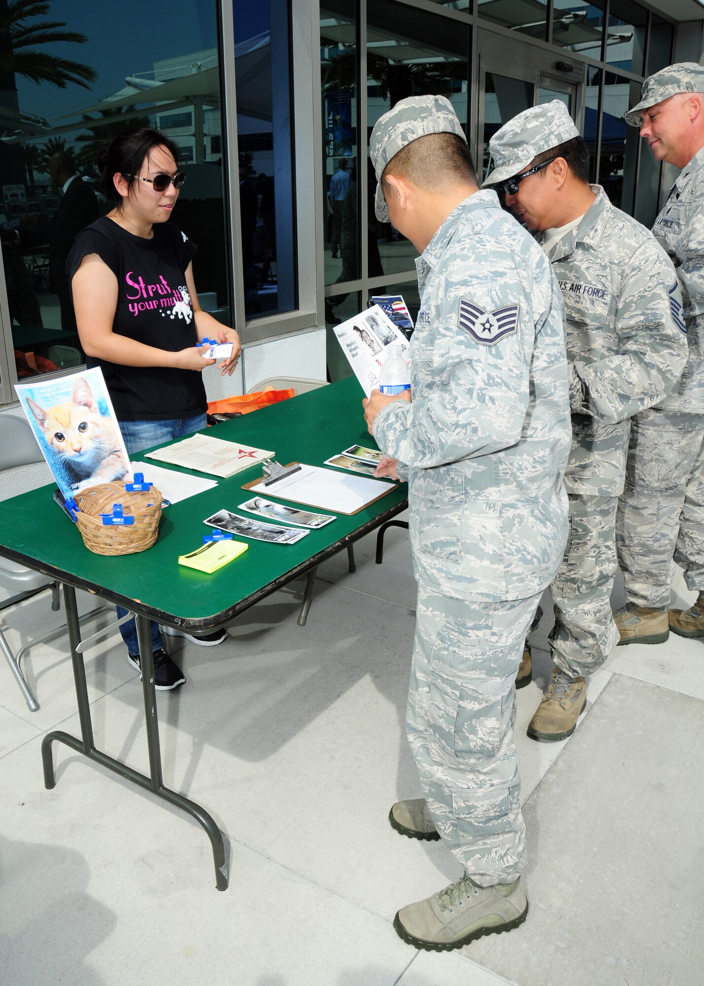 Airmen talk to a representative from the Society for the Prevention of Cruelty to Animals at the CFC kickoff event, Sept. 27. Representatives from a number of charities attended to talk about their organizations.  Employees can specify which charities they want their CFC pledge to go towards.  (Photo by Jim Gordon)