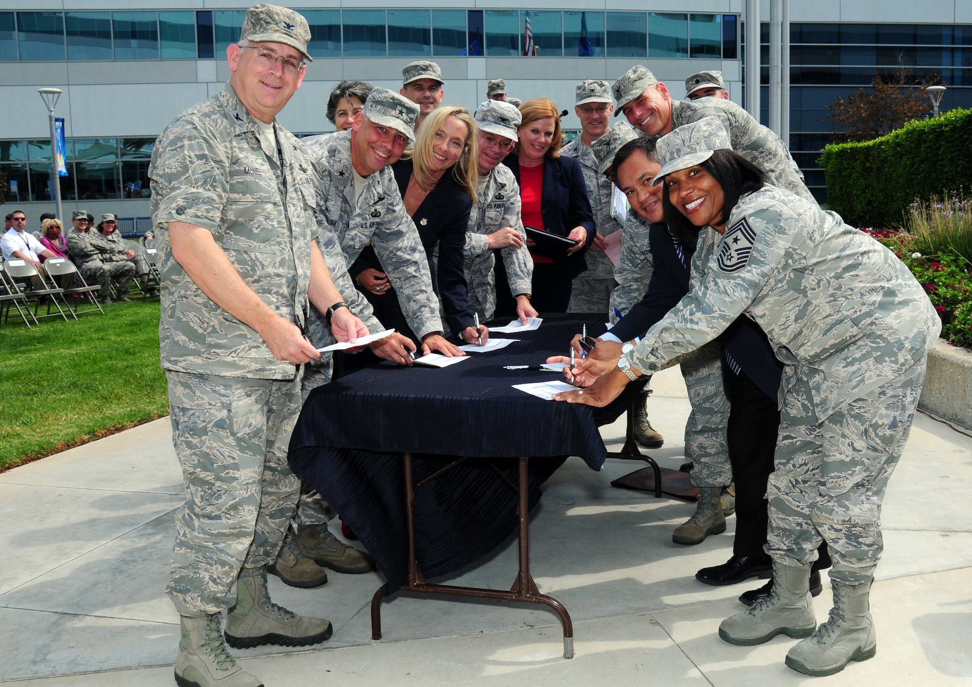 Colonel Sam McNiel, 61st Air Base Group commander and Chief Master Sergeant Carol Dockery, SMC command chief master sergeant, are joined by other base leaders to sign their Combined Federal Campaign pledge cards at the CFC kickoff, Sept. 27.  This year’s CFC drive runs until mid December in the greater Los Angeles area.  (Photo by Jim Gordon)